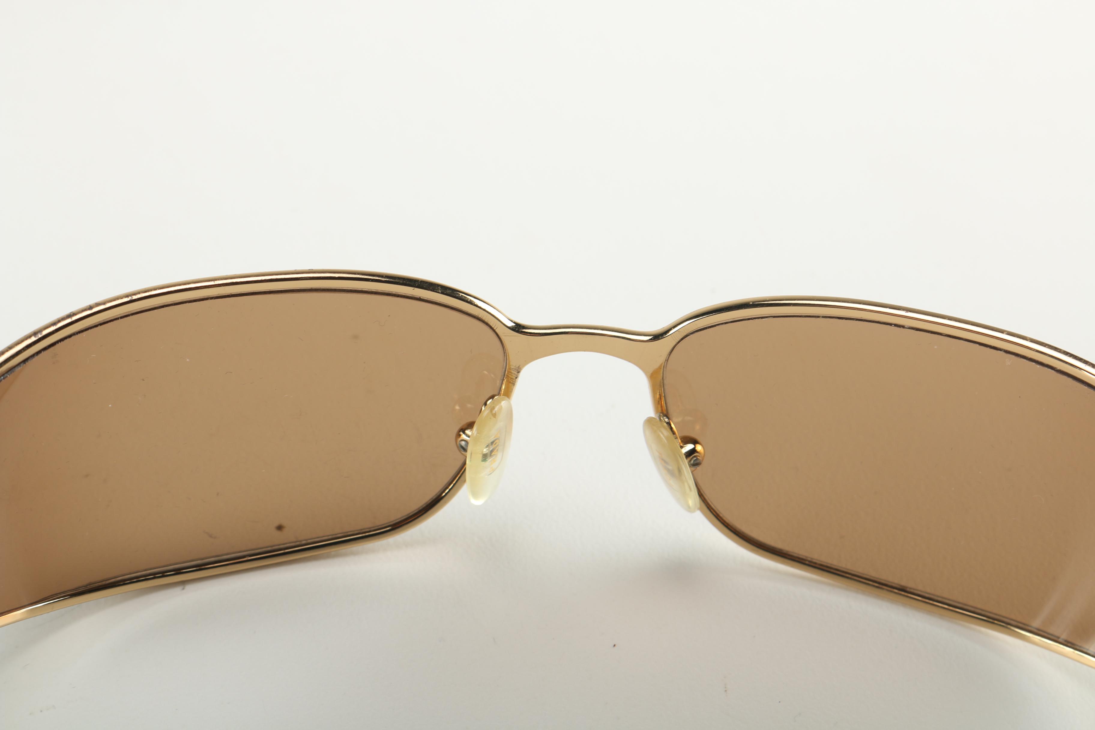 Sunglasses by Prada and Escada