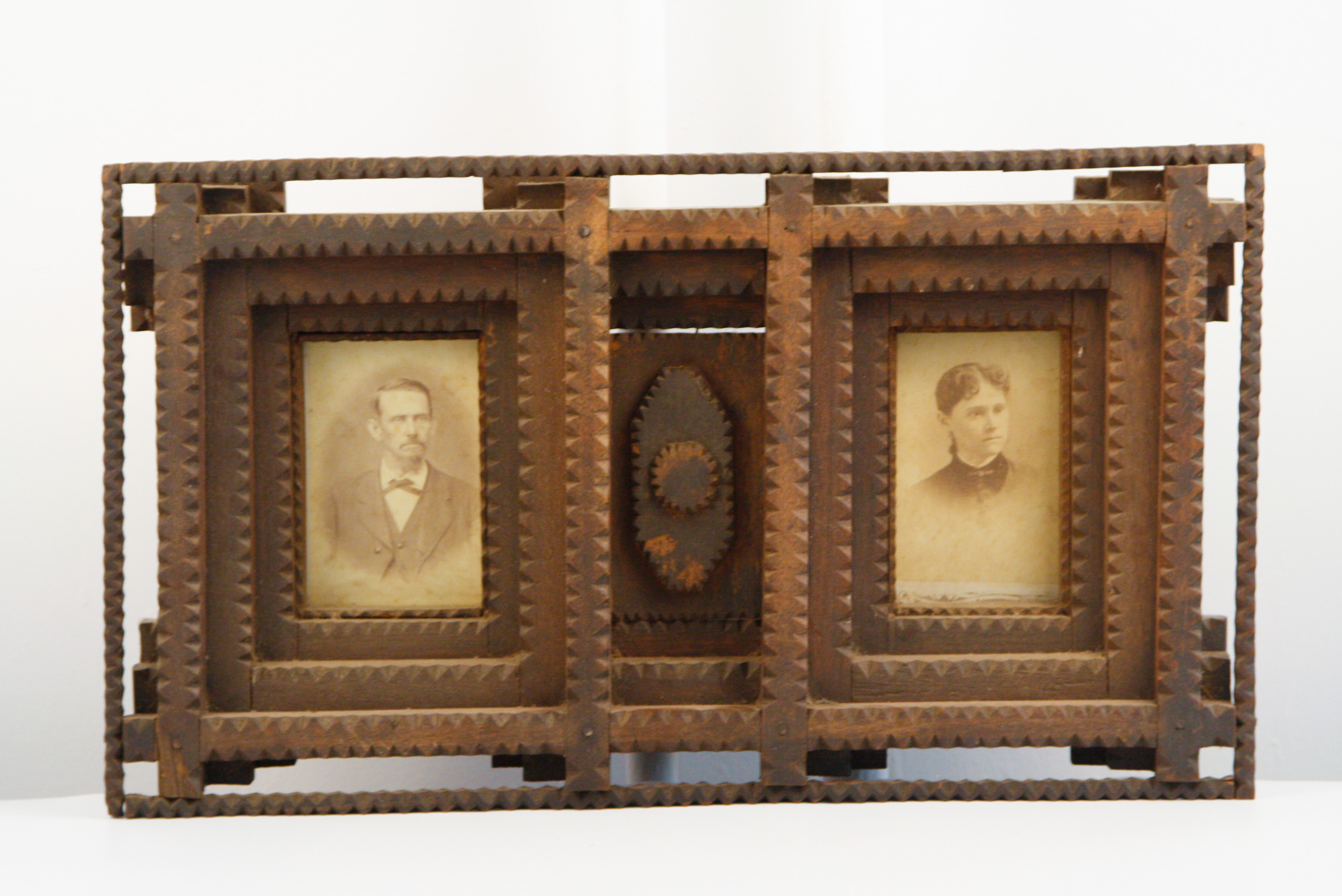 Carved Tramp Art Frame with Pair of Antique Portraits