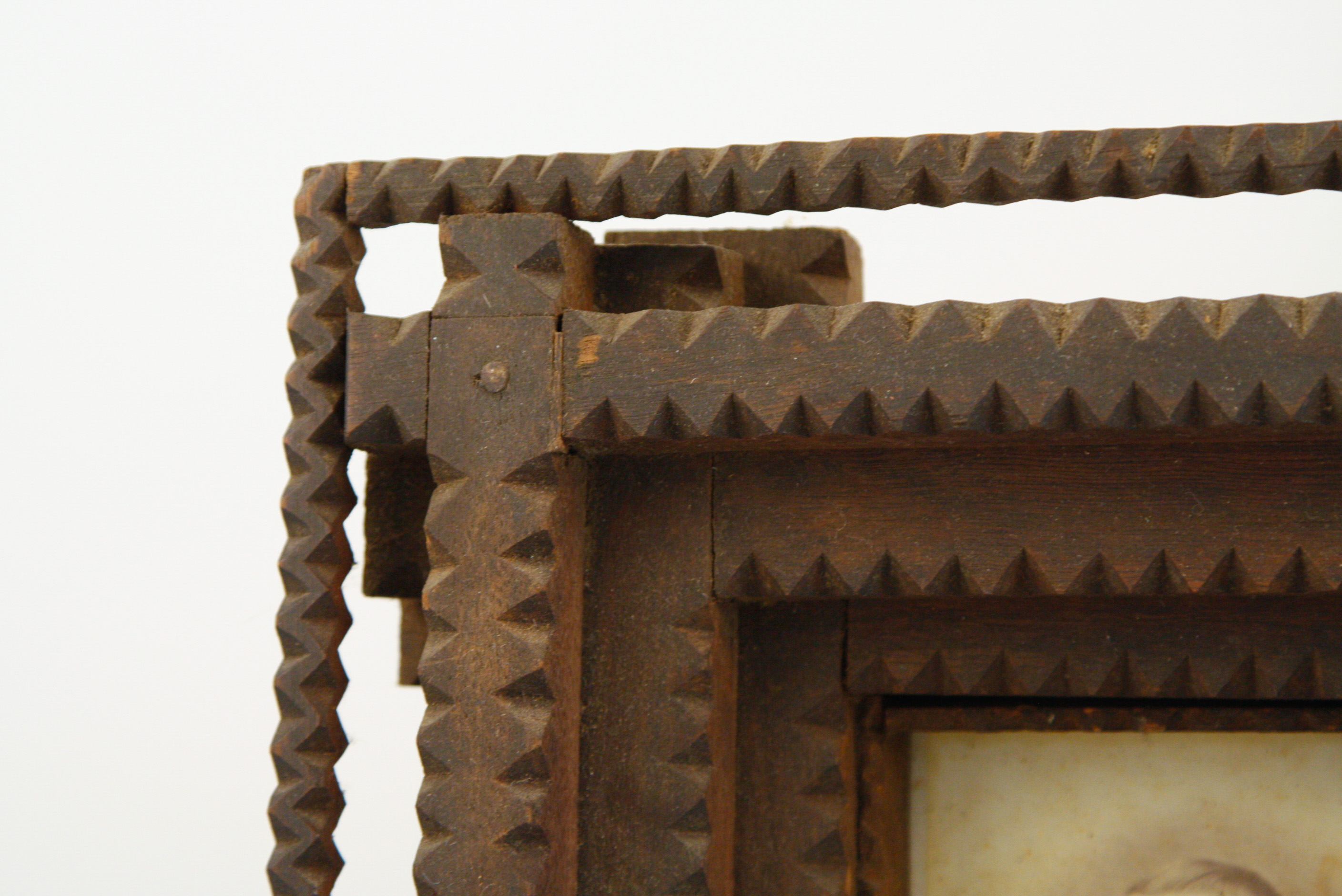 Carved Tramp Art Frame with Pair of Antique Portraits