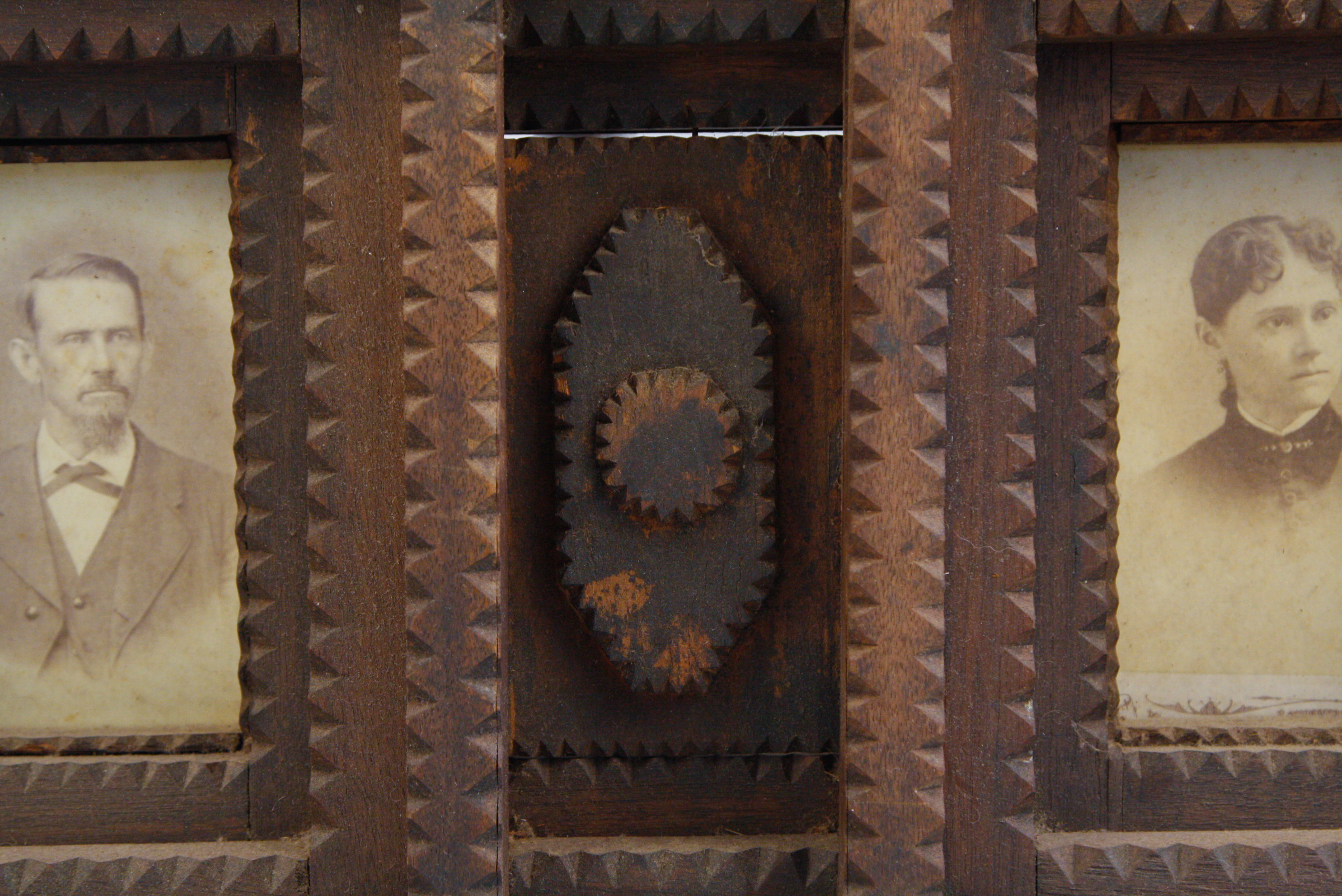 Carved Tramp Art Frame with Pair of Antique Portraits