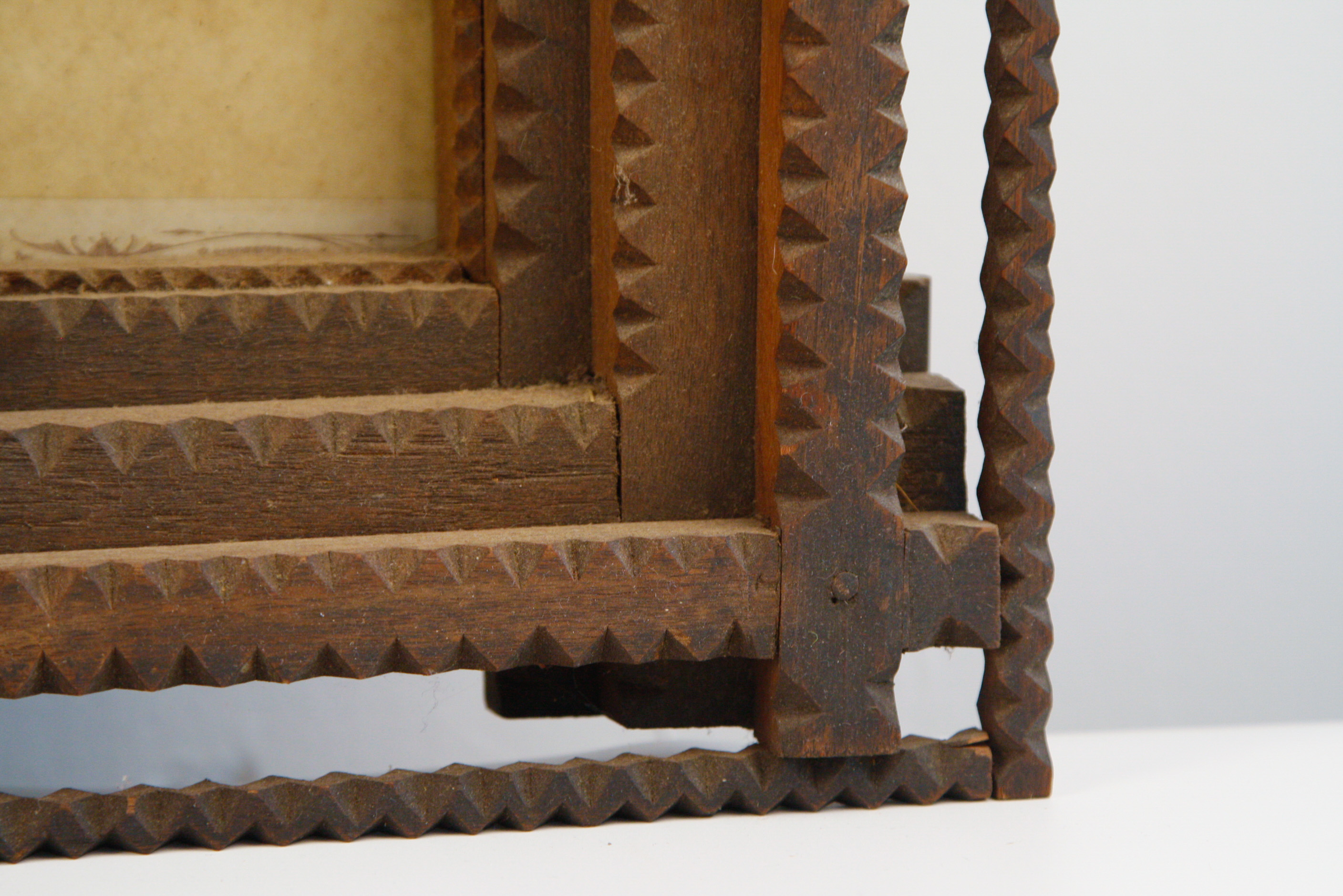 Carved Tramp Art Frame with Pair of Antique Portraits