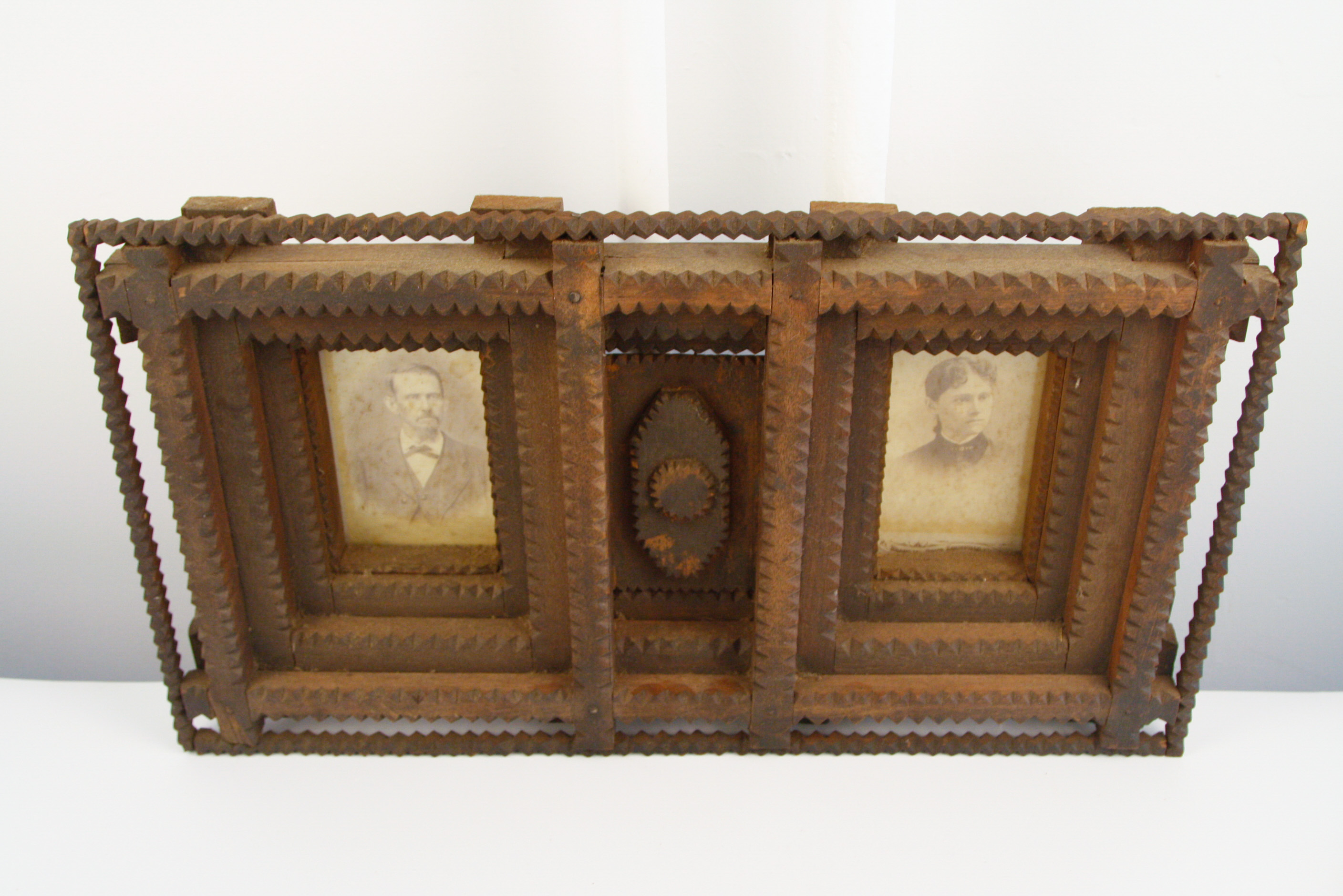Carved Tramp Art Frame with Pair of Antique Portraits