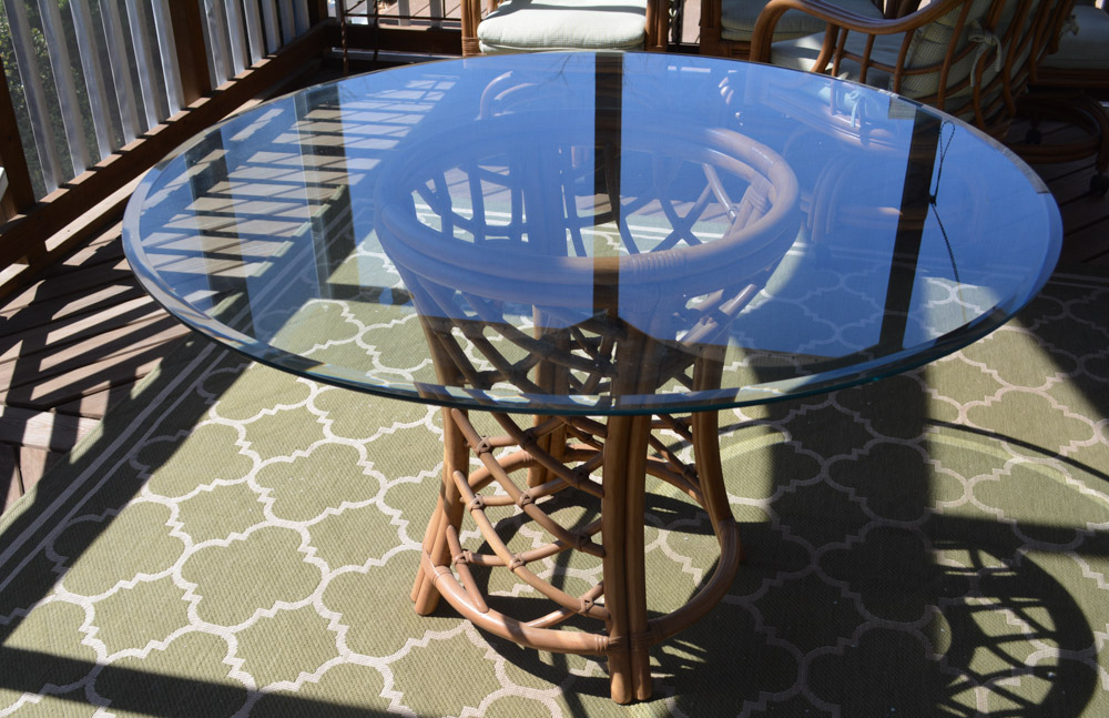 Glass-Top Pedestal Table with Rattan Chairs