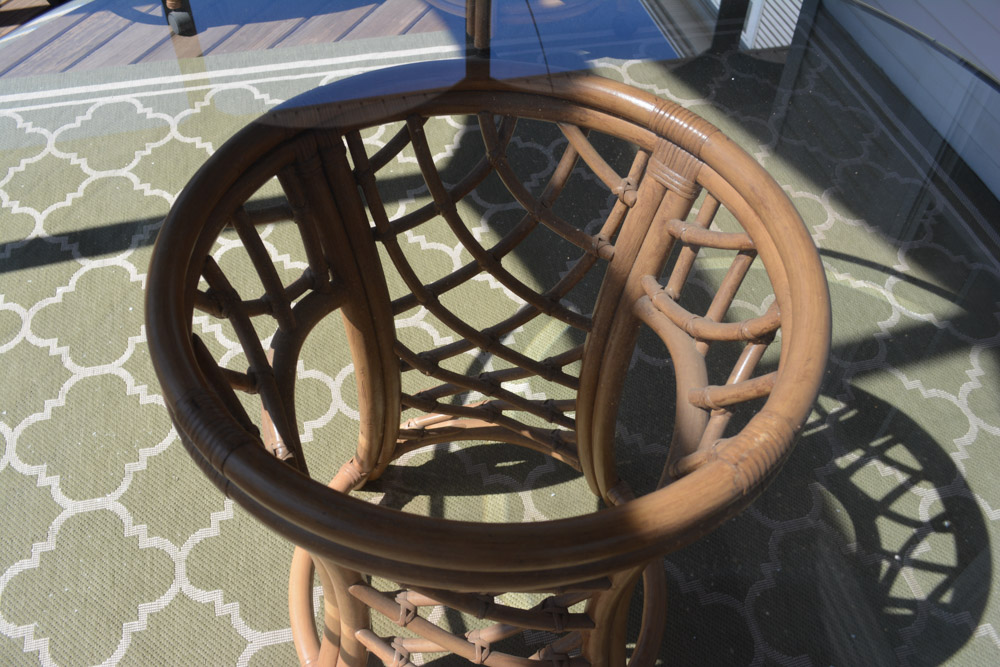 Glass-Top Pedestal Table with Rattan Chairs