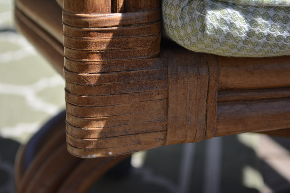 Glass-Top Pedestal Table with Rattan Chairs