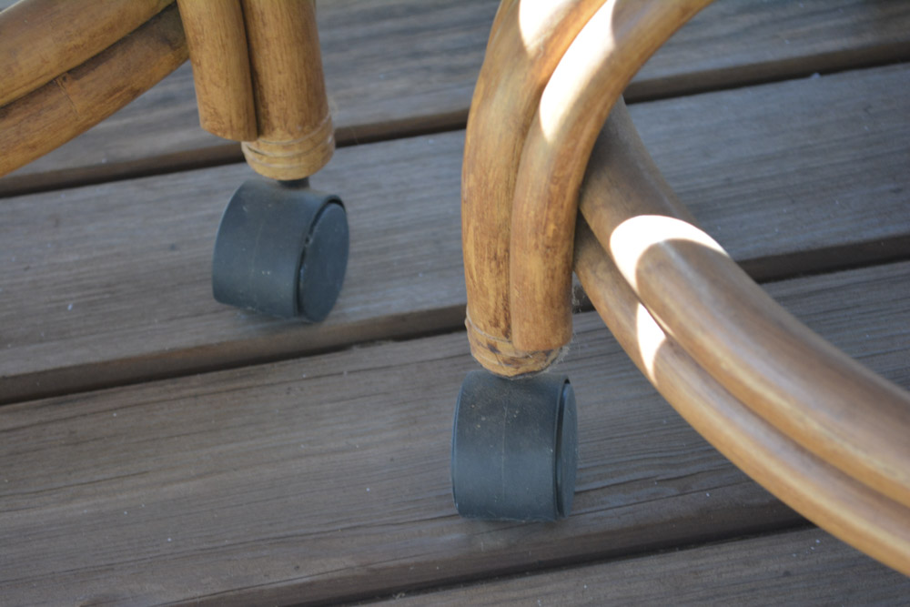 Glass-Top Pedestal Table with Rattan Chairs