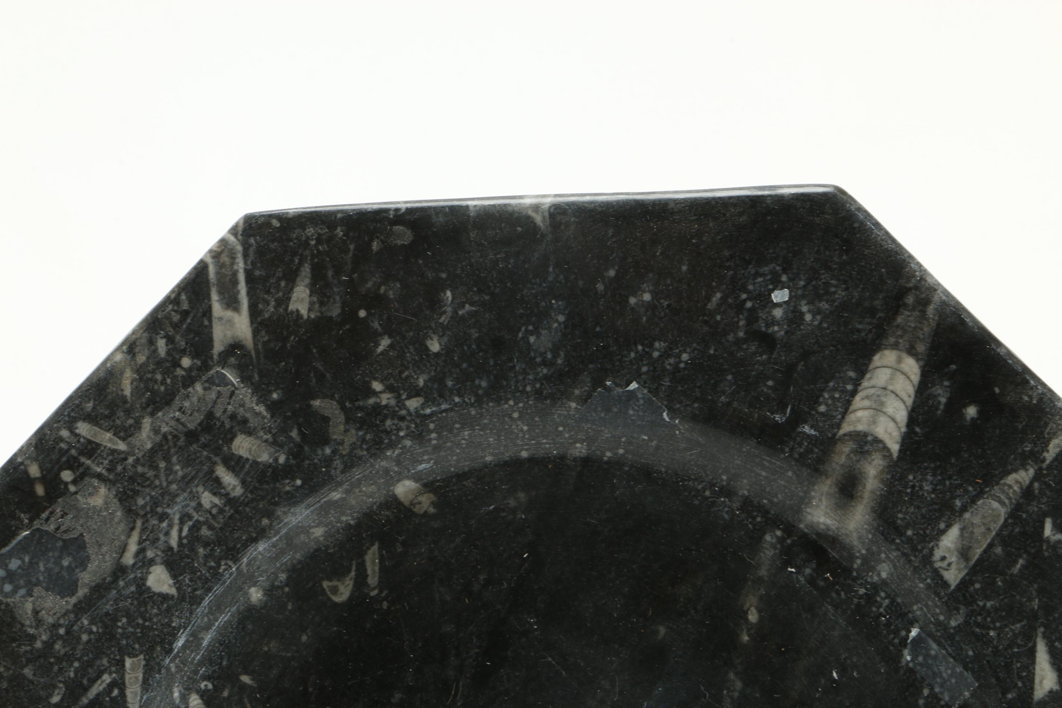 Black Fossiliferous Limestone Plate with a Mortar and Pestle