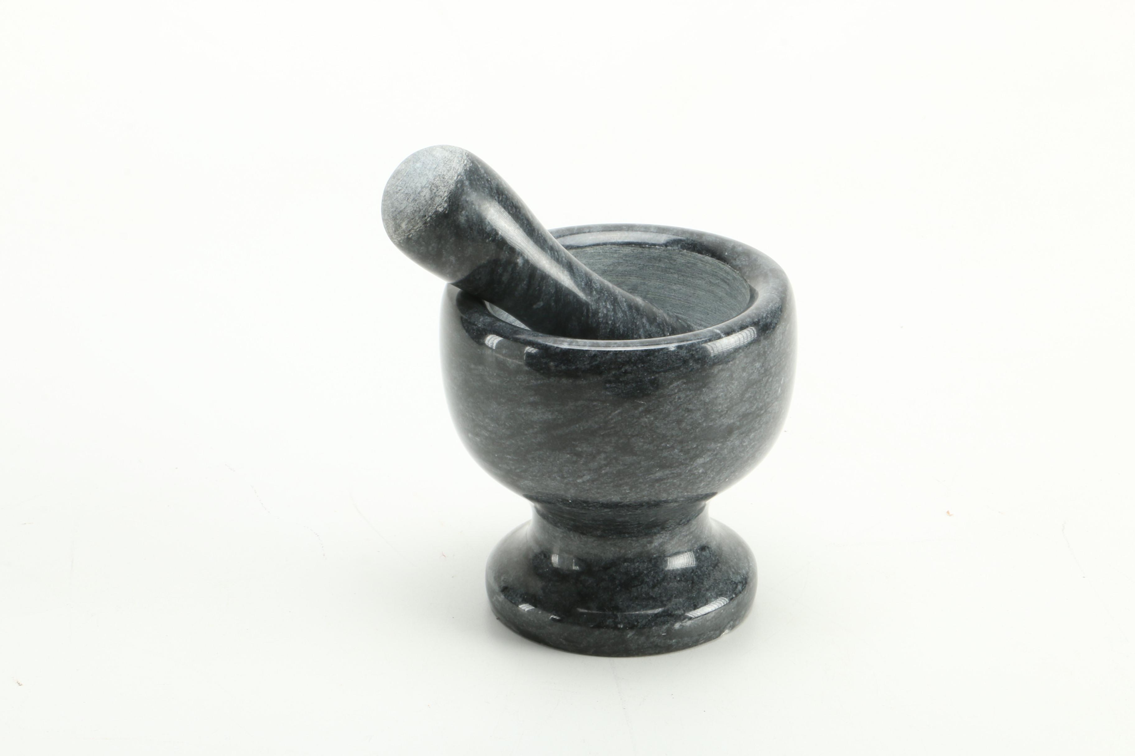 Black Fossiliferous Limestone Plate with a Mortar and Pestle