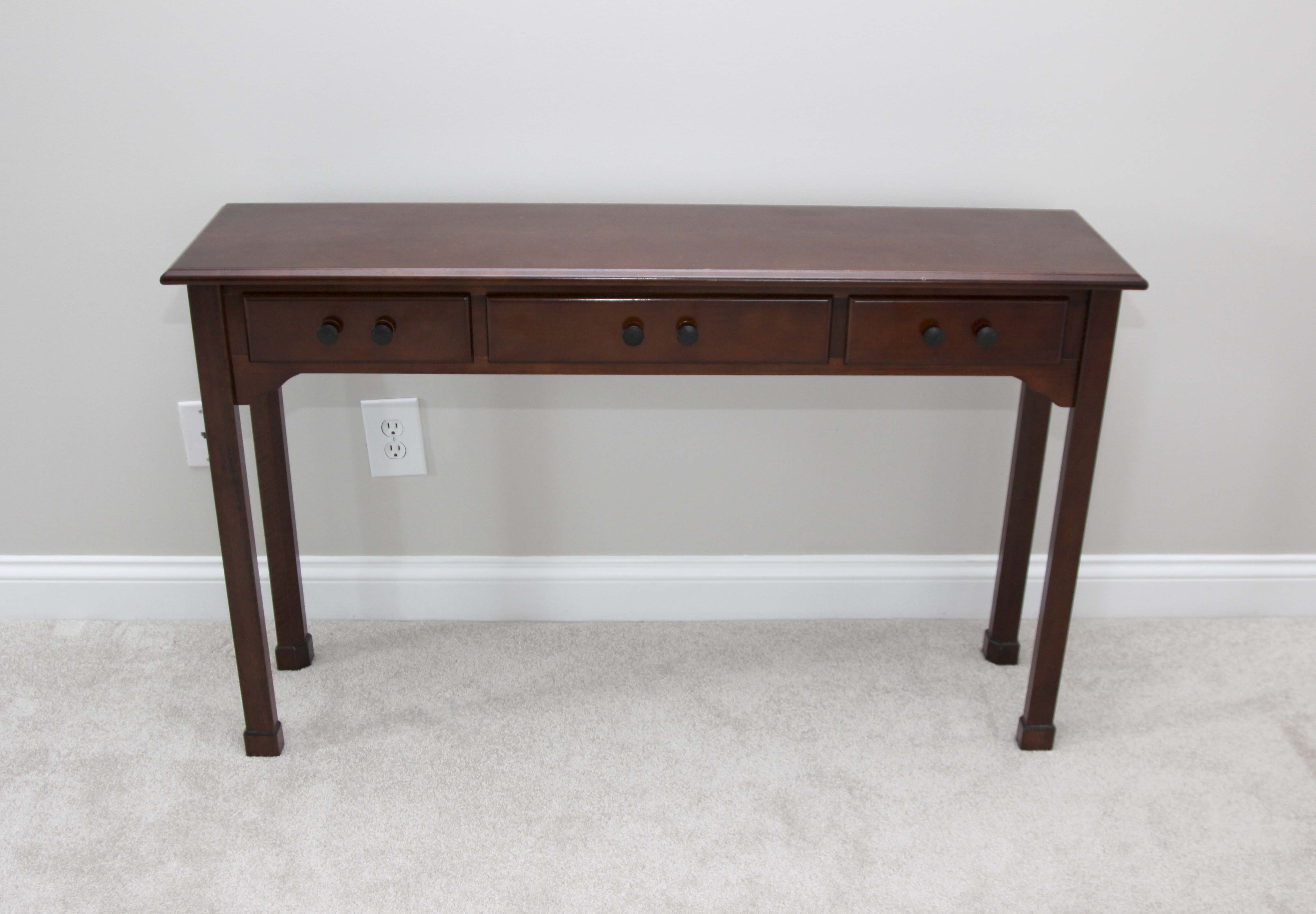A Three Drawer Console Table