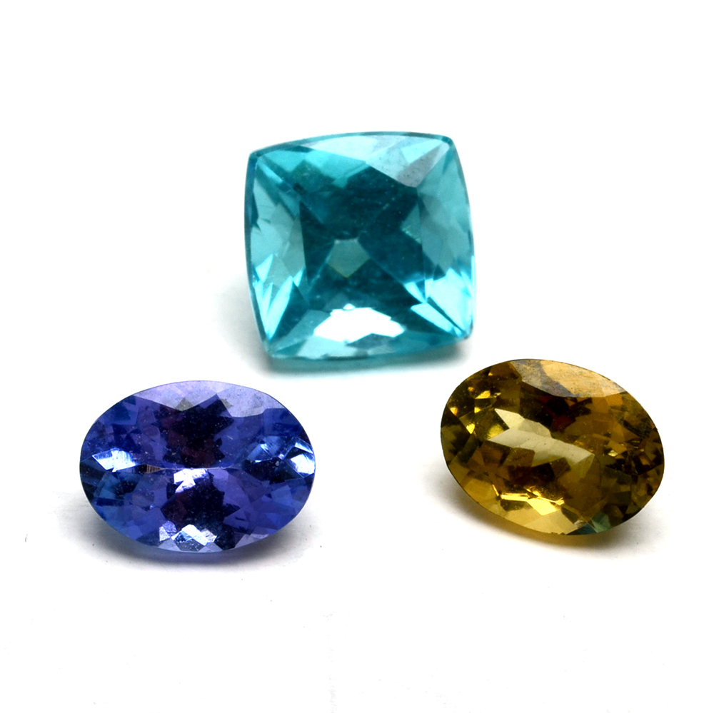 A group of Loose Tanzanite, Zoisite and Neon Apatite Gemstones