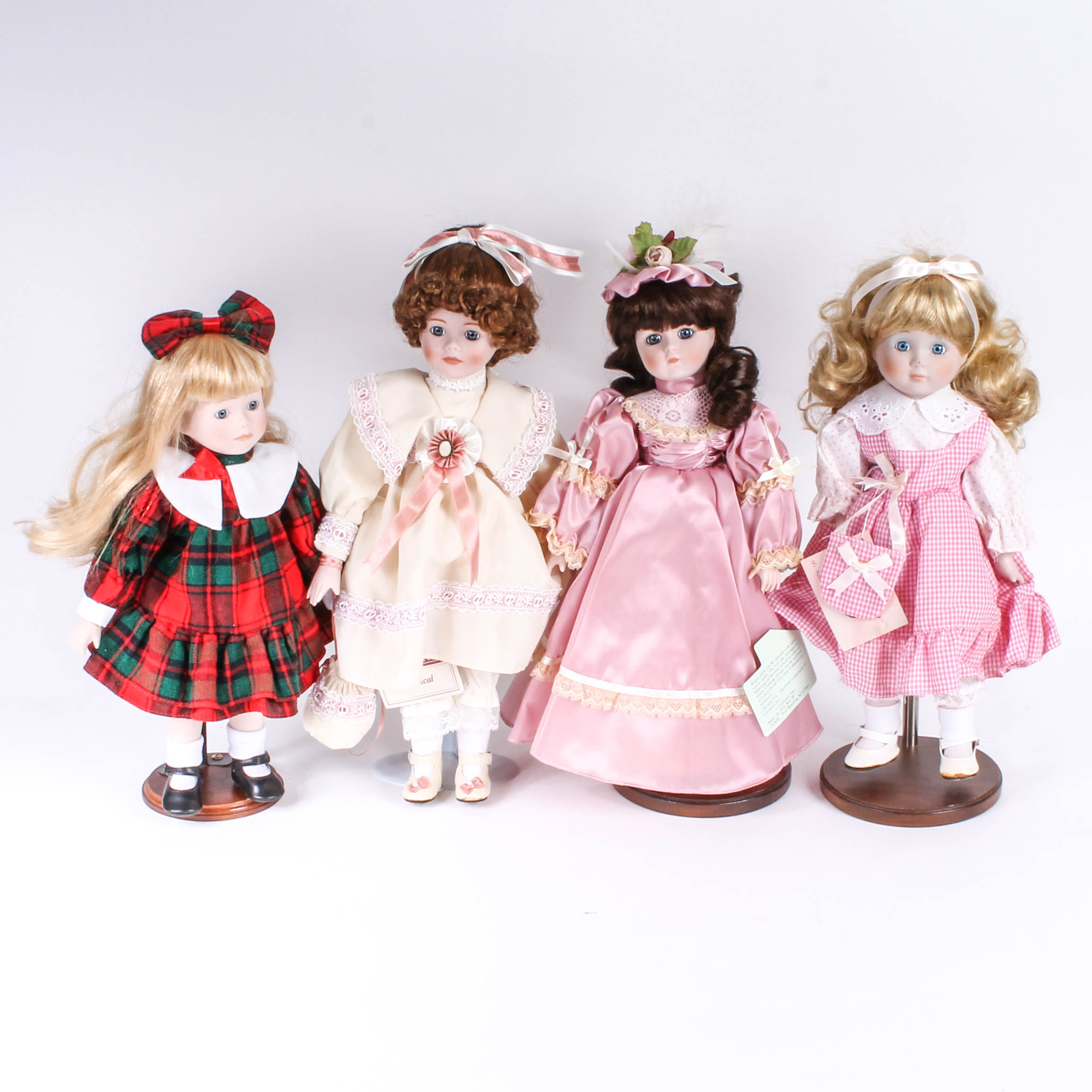 Four Porcelain Dolls by Dynasty Doll