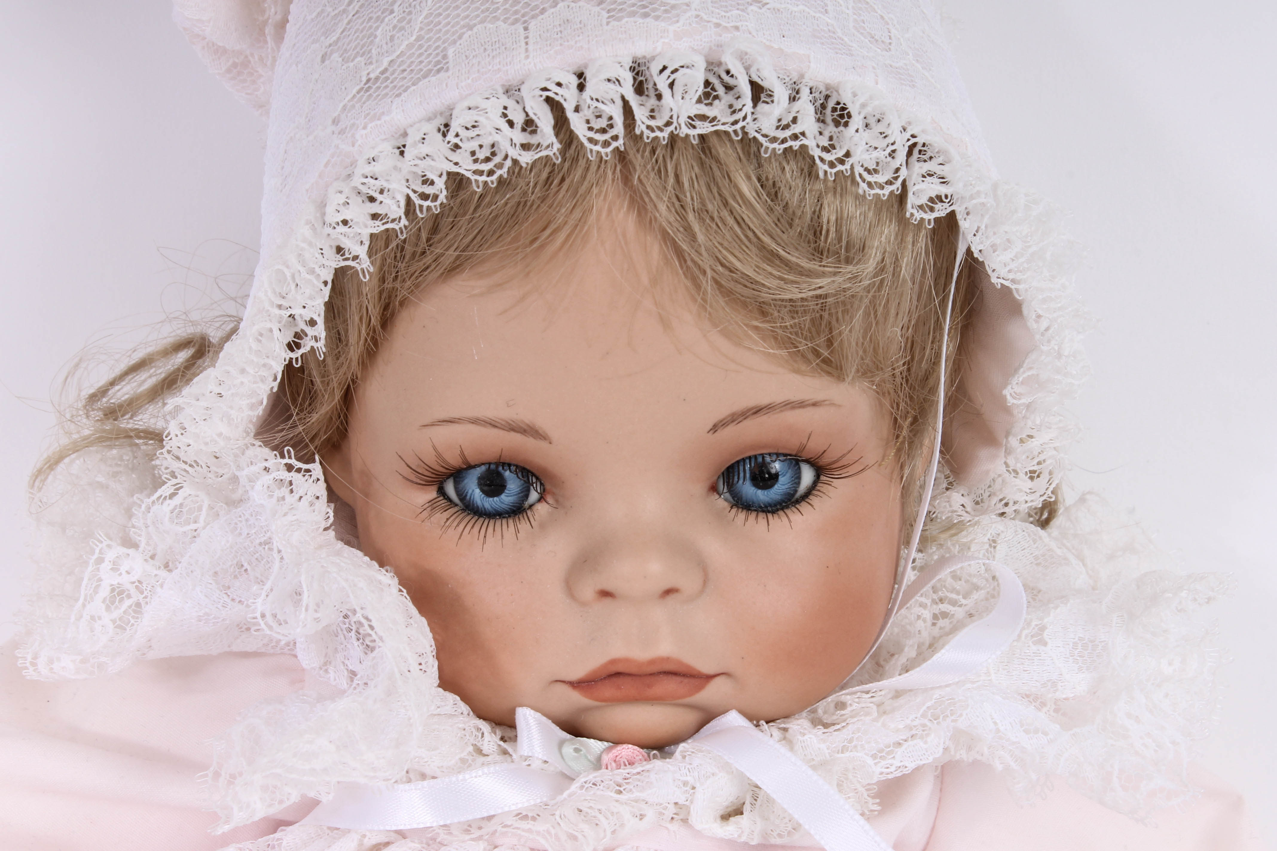 Handmade Porcelain Doll in Wicker Bassinet