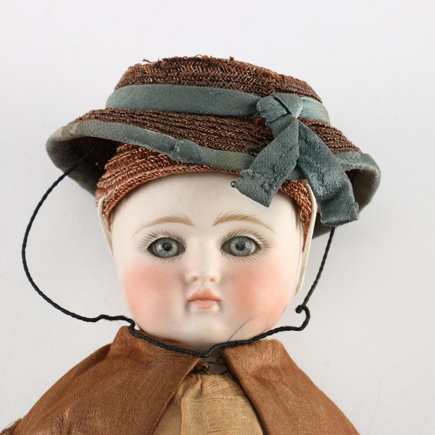 Antique Hand-Painted Bisque Doll With Inset Eyes and Leather Body