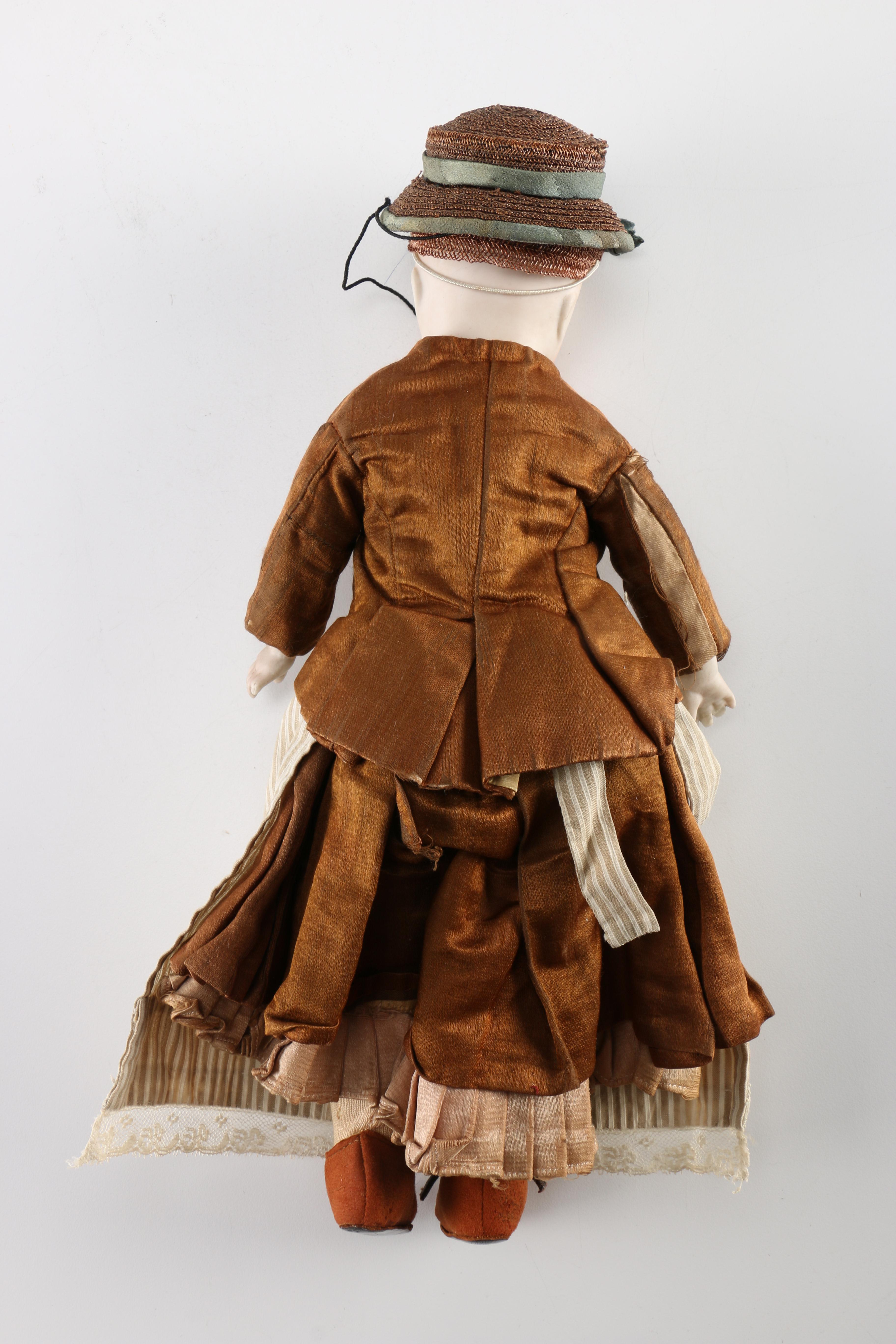 Antique Hand-Painted Bisque Doll With Inset Eyes and Leather Body