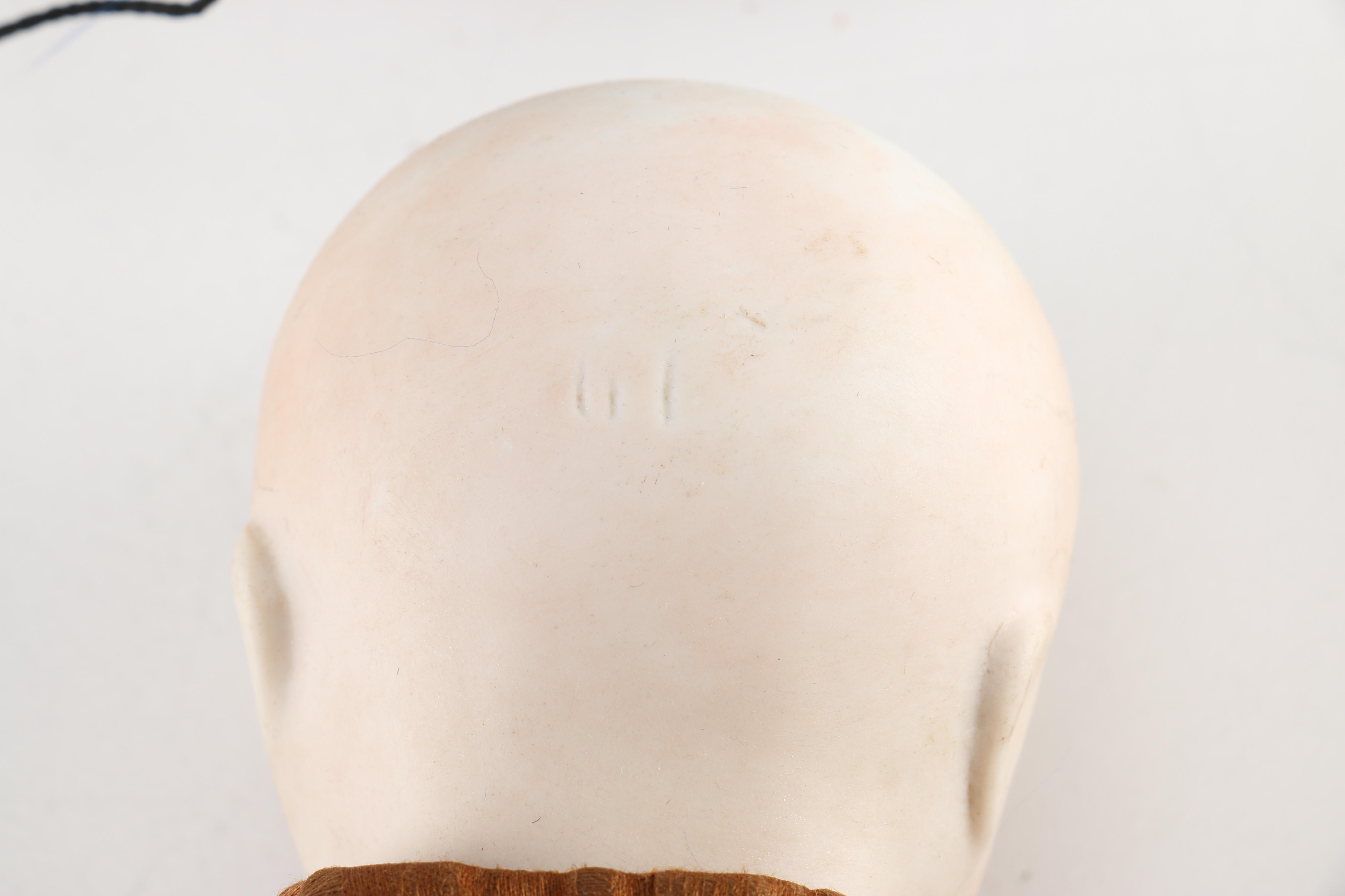 Antique Hand-Painted Bisque Doll With Inset Eyes and Leather Body