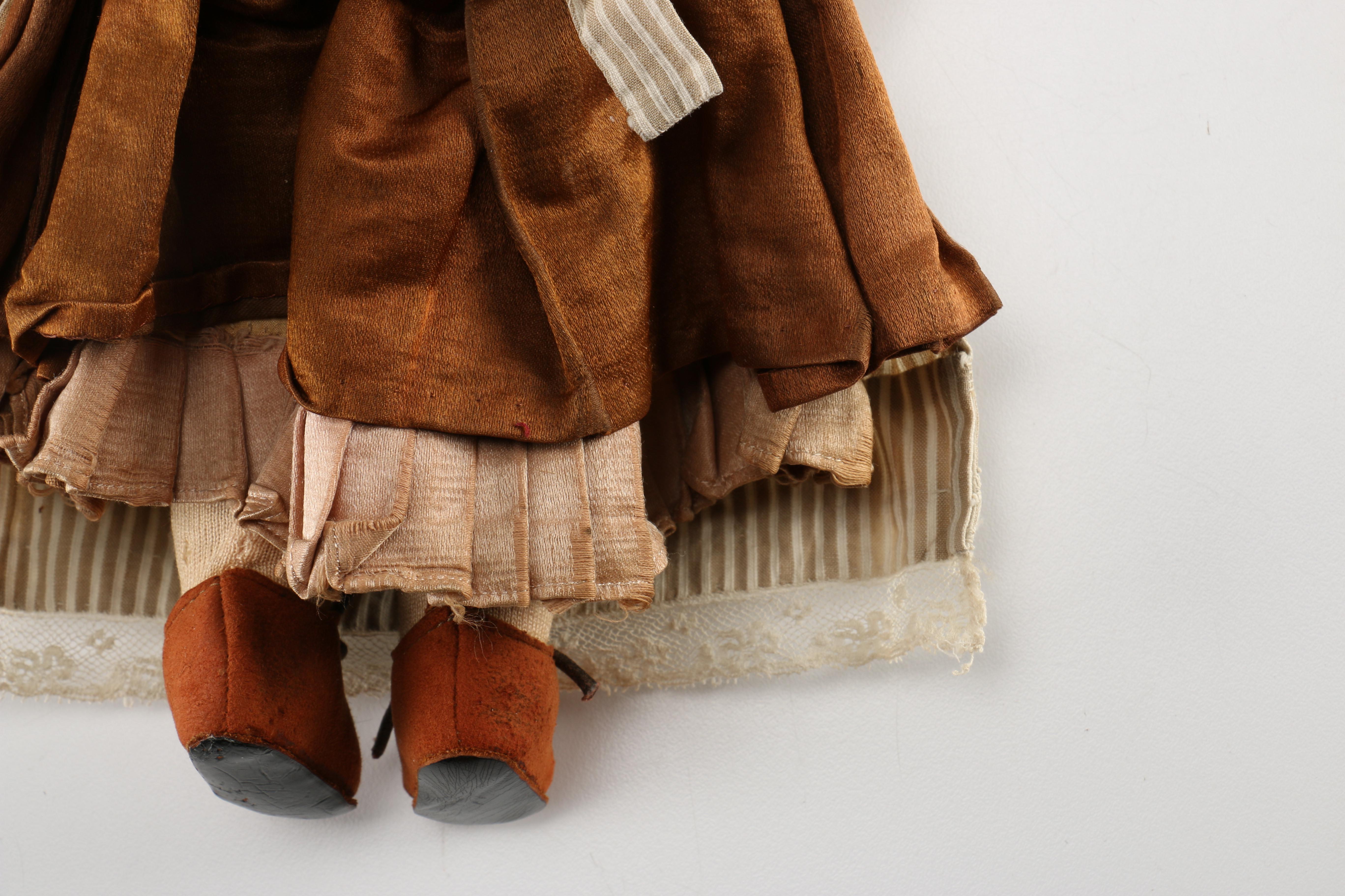 Antique Hand-Painted Bisque Doll With Inset Eyes and Leather Body