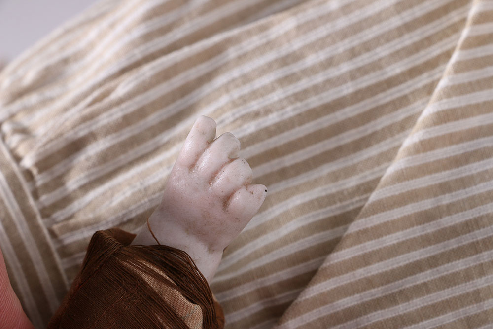 Antique Hand-Painted Bisque Doll With Inset Eyes and Leather Body