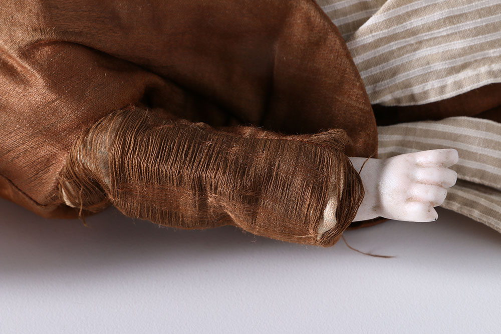 Antique Hand-Painted Bisque Doll With Inset Eyes and Leather Body