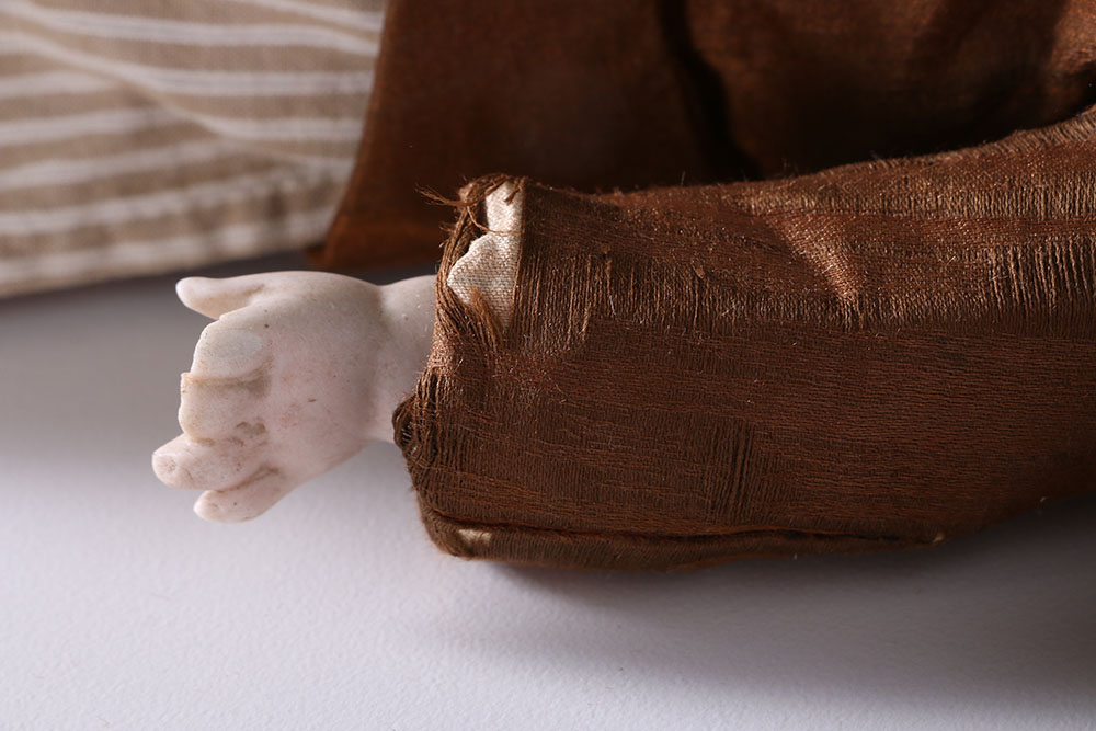 Antique Hand-Painted Bisque Doll With Inset Eyes and Leather Body