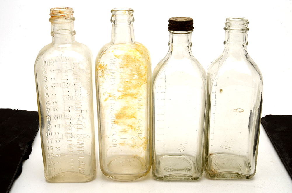 Four Vintage Embalming Fluid Bottles