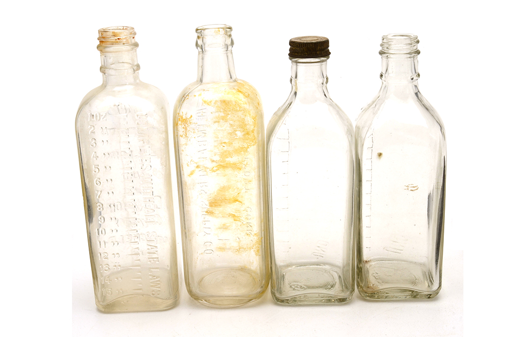 Four Vintage Embalming Fluid Bottles