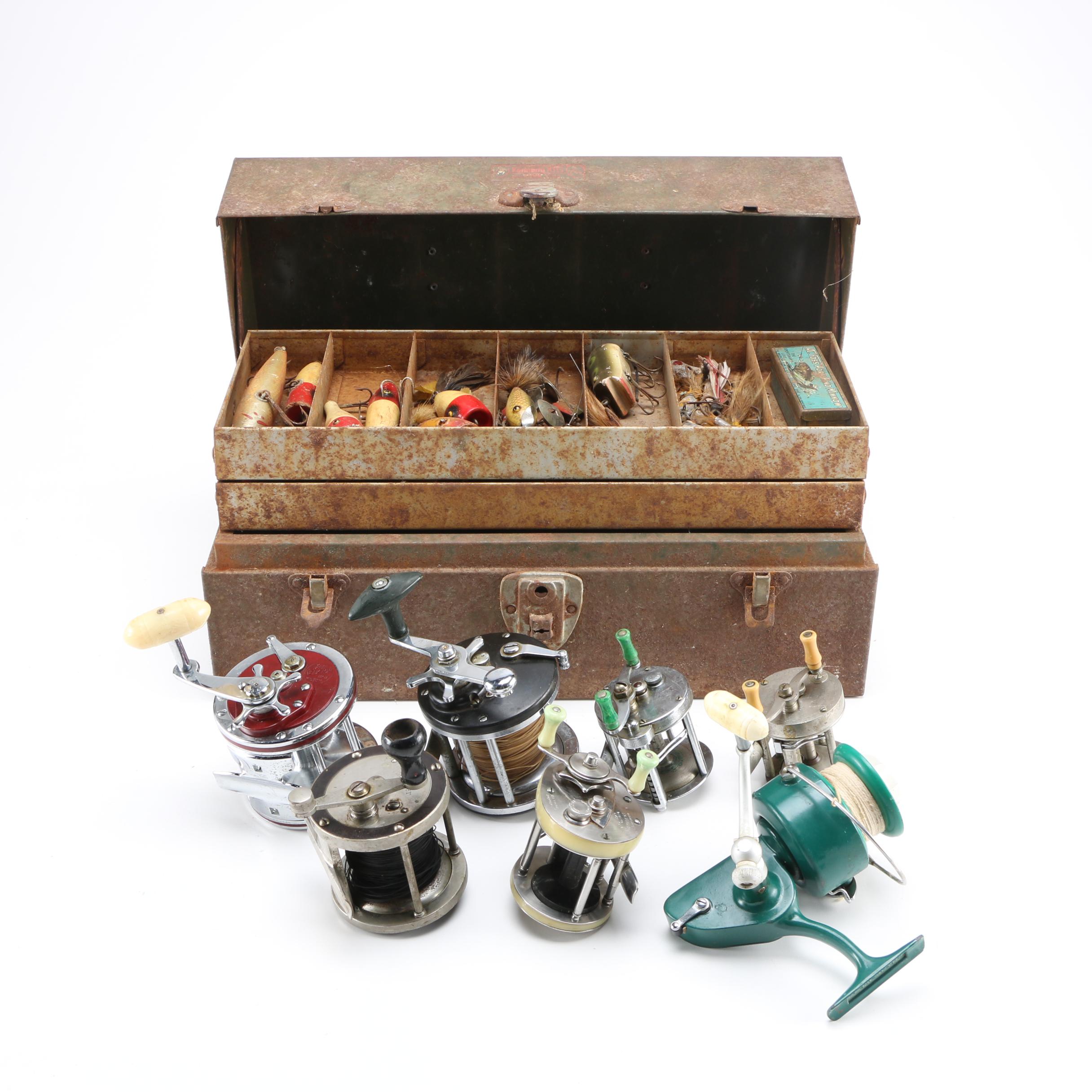 Collection of Vintage Fishing Lures and Reels With Tackle Box