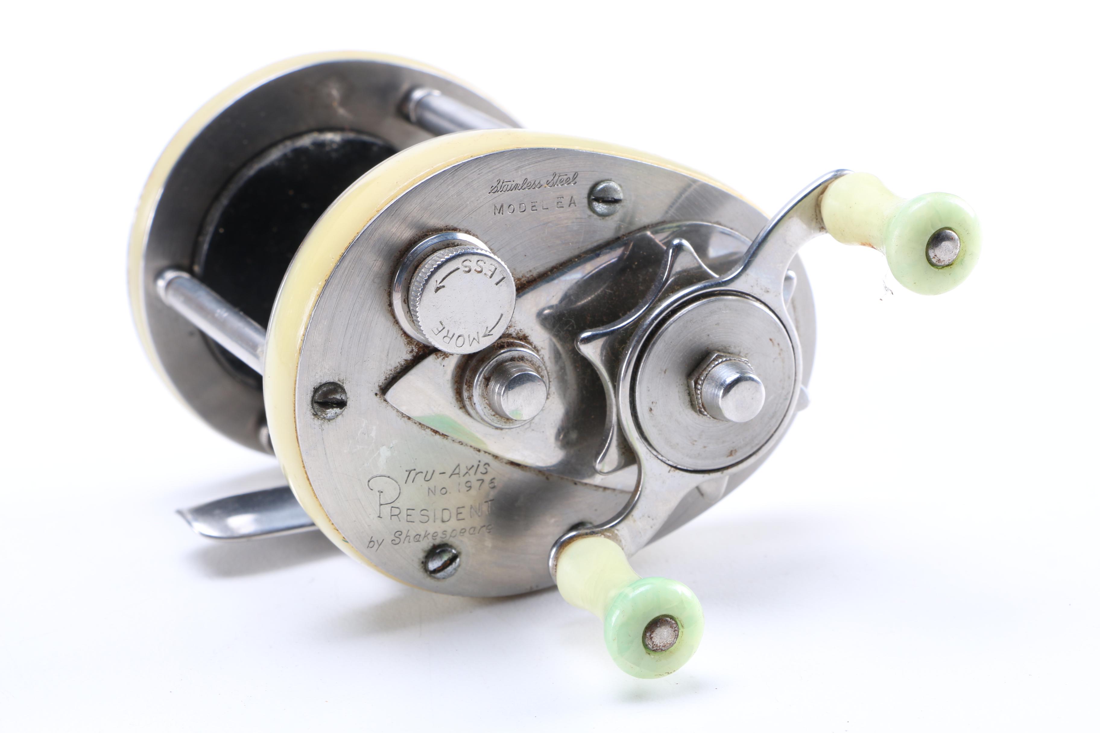 Collection of Vintage Fishing Lures and Reels With Tackle Box