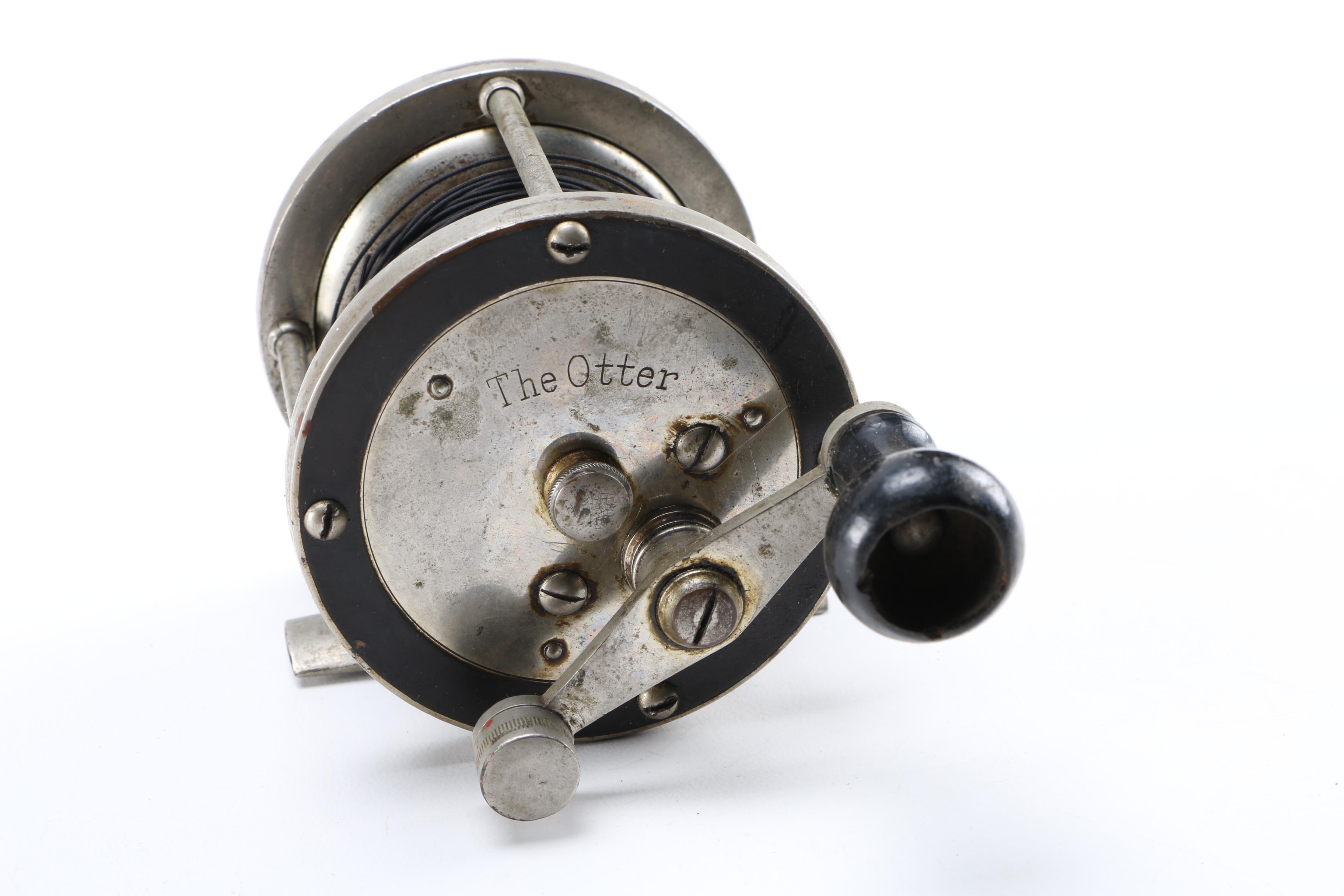 Collection of Vintage Fishing Lures and Reels With Tackle Box