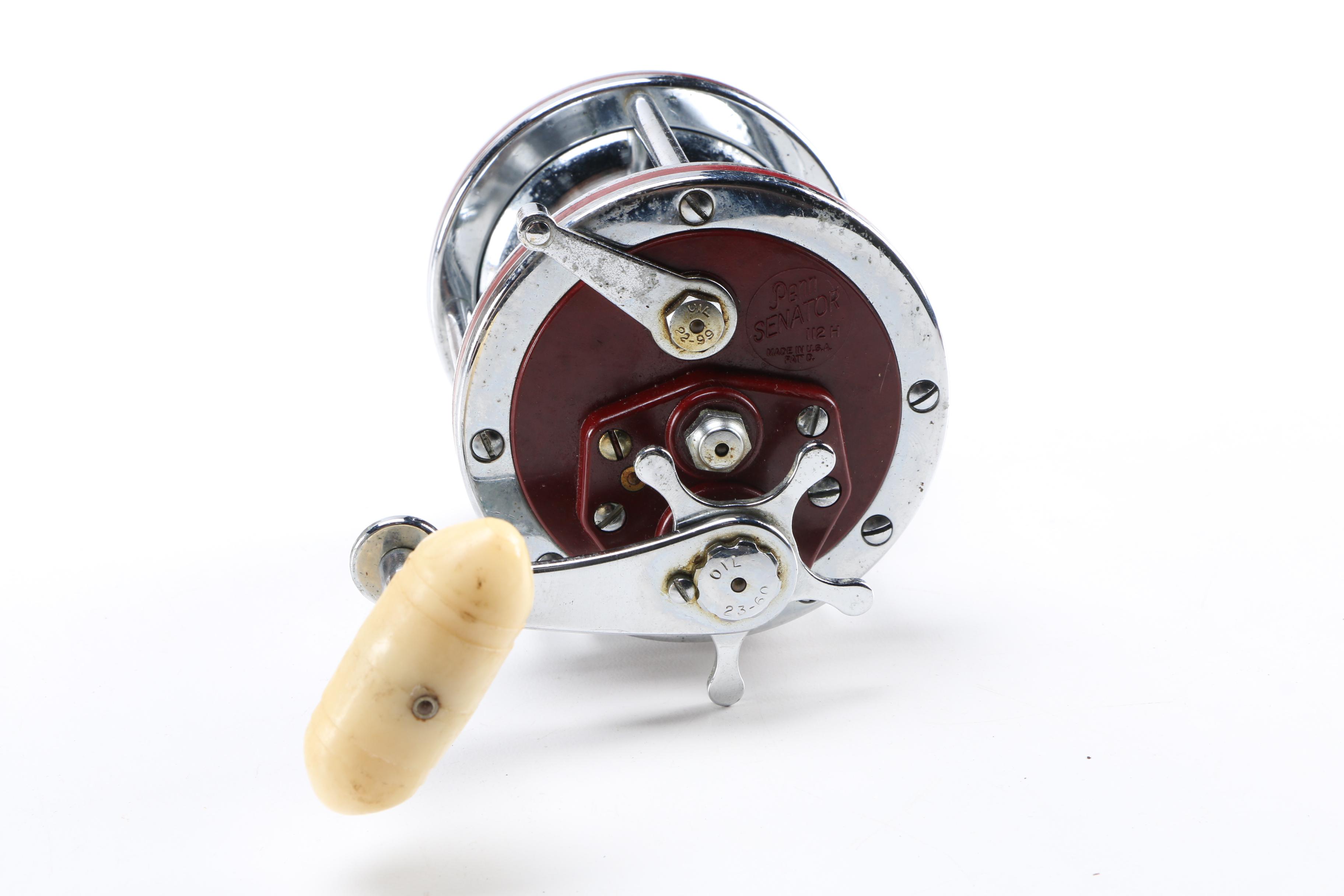 Collection of Vintage Fishing Lures and Reels With Tackle Box