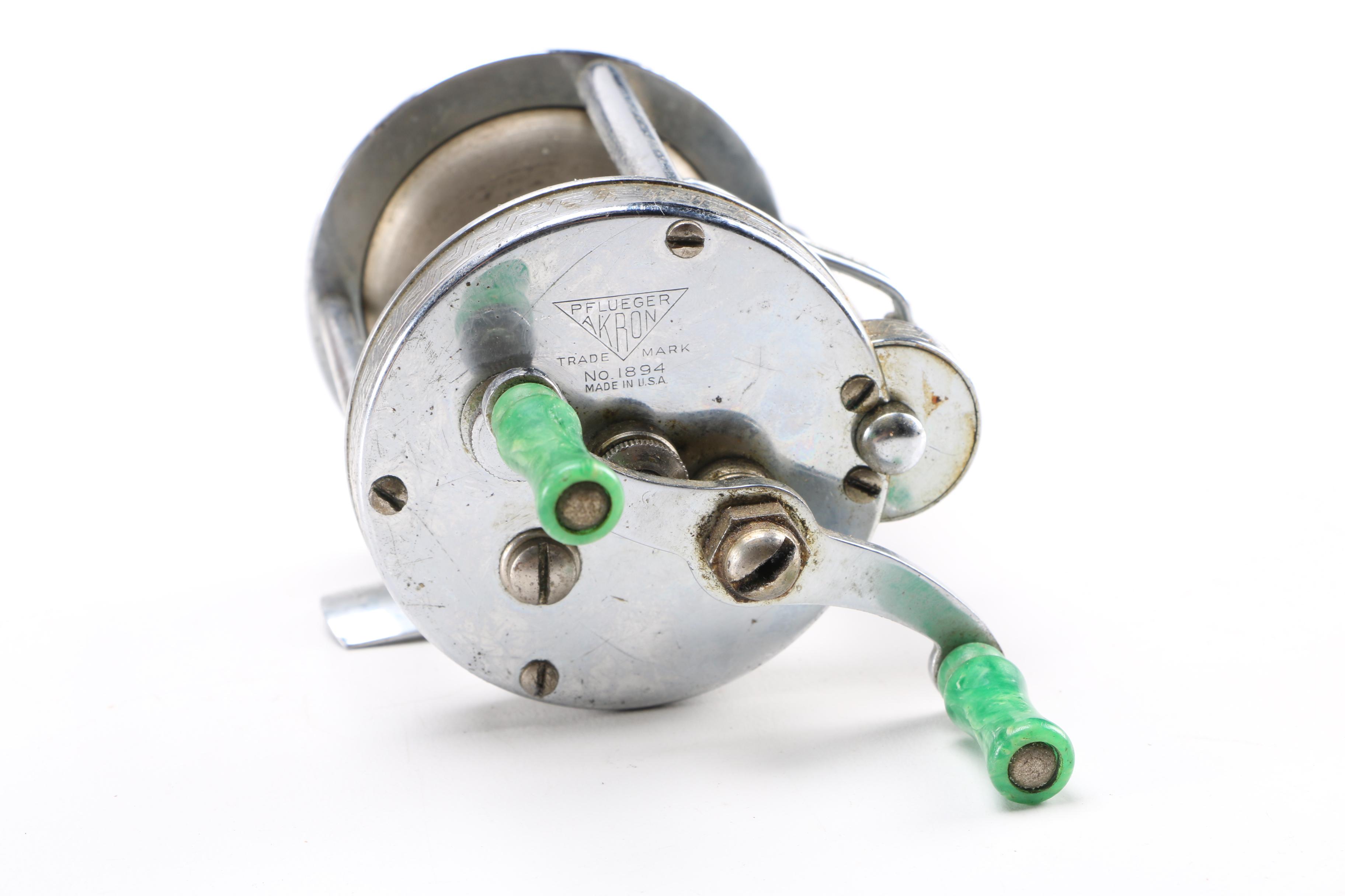 Collection of Vintage Fishing Lures and Reels With Tackle Box