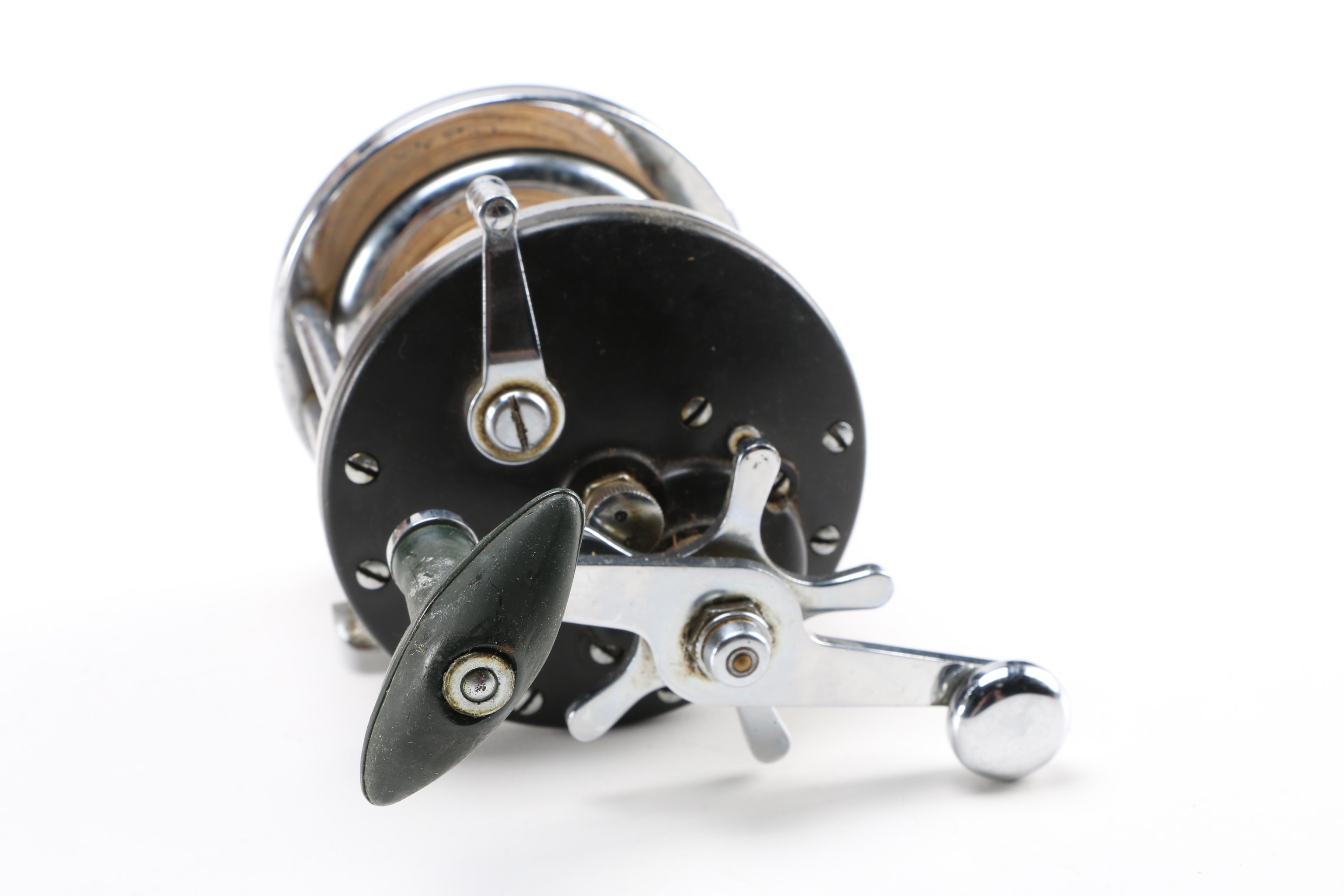 Collection of Vintage Fishing Lures and Reels With Tackle Box