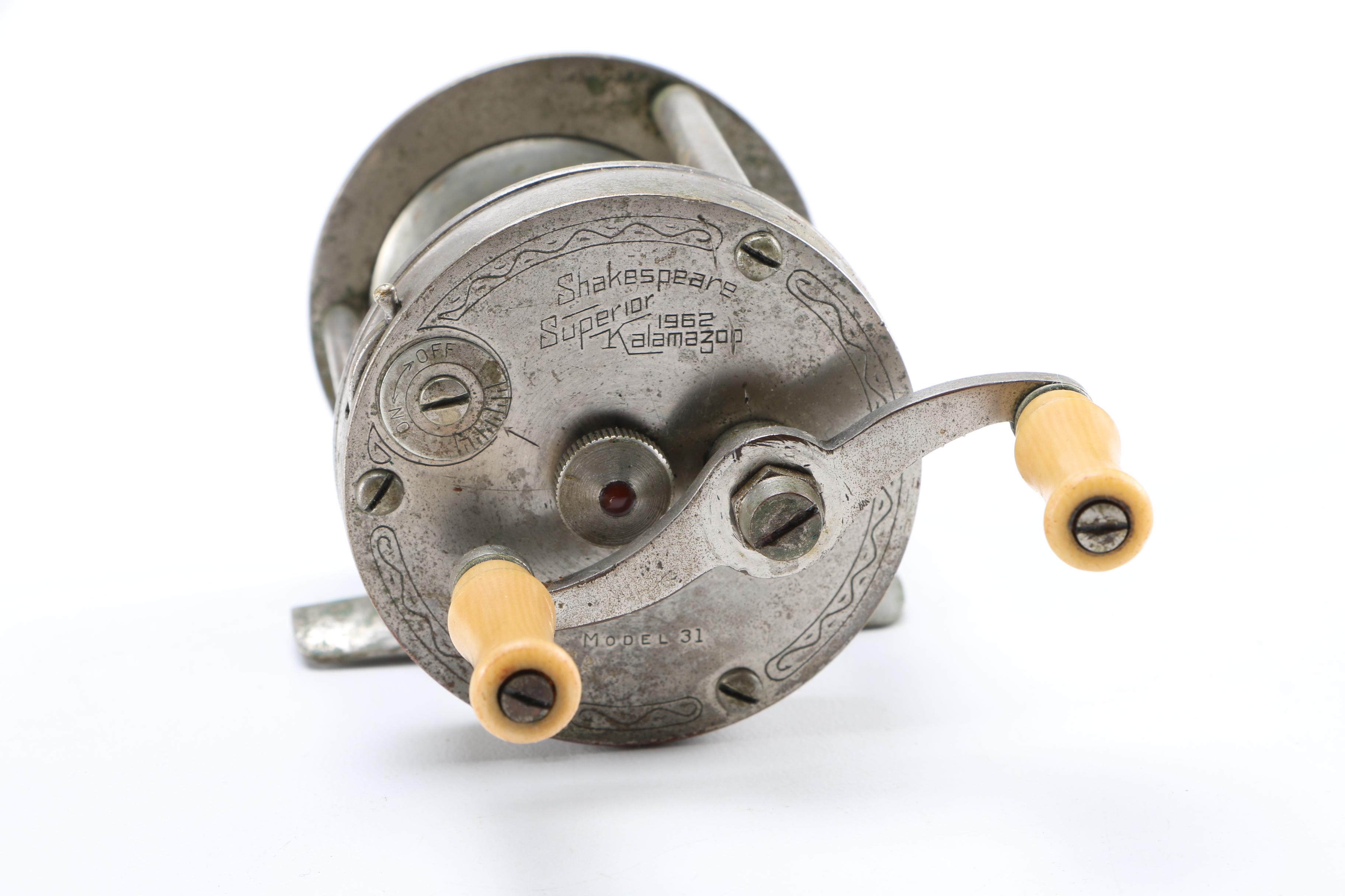 Collection of Vintage Fishing Lures and Reels With Tackle Box