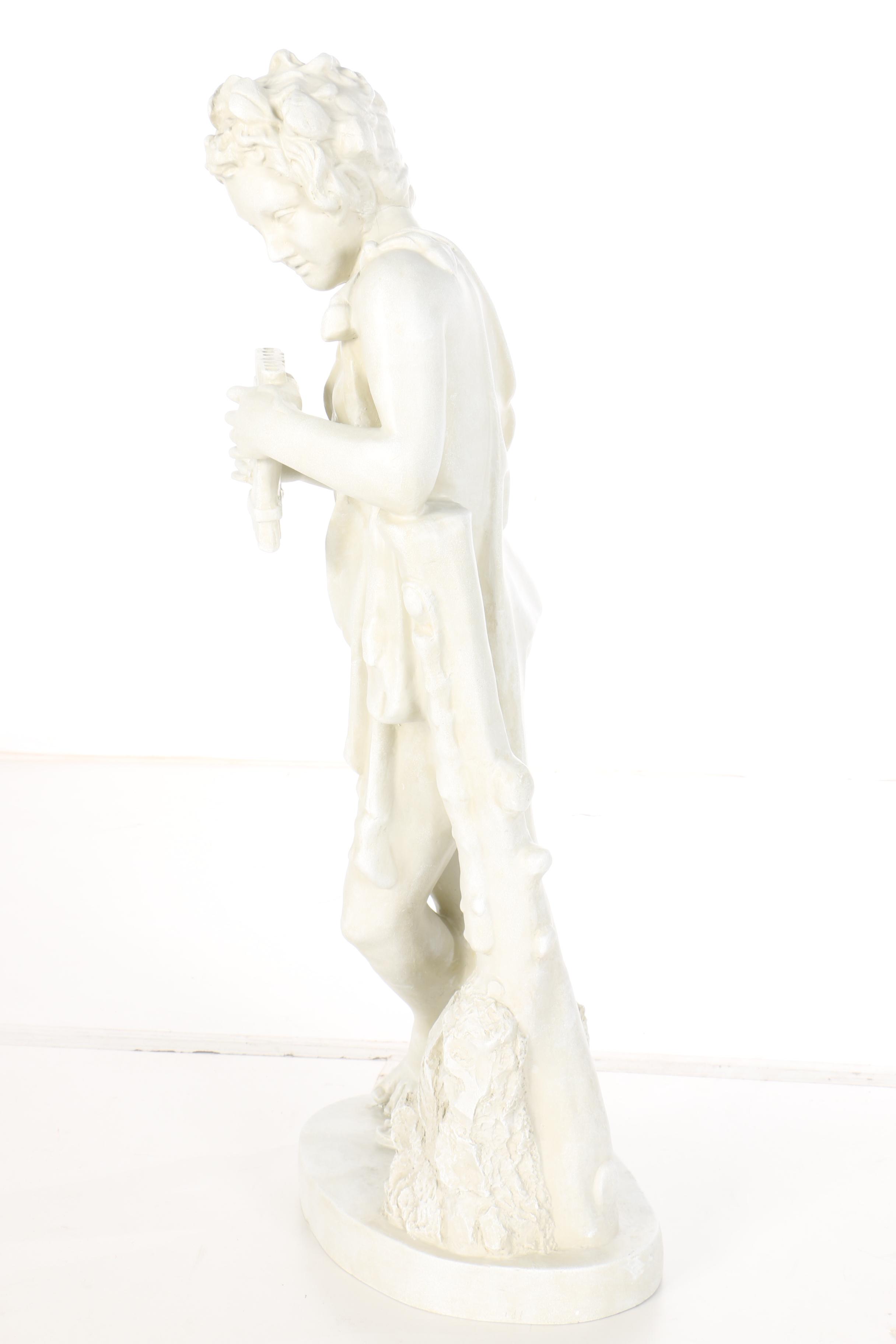 Sculpture of a Boy Holding a Panpipe