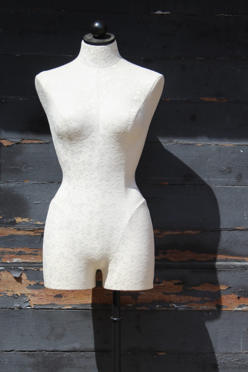 White Upholstered Dress Form On Wrought Iron Stand