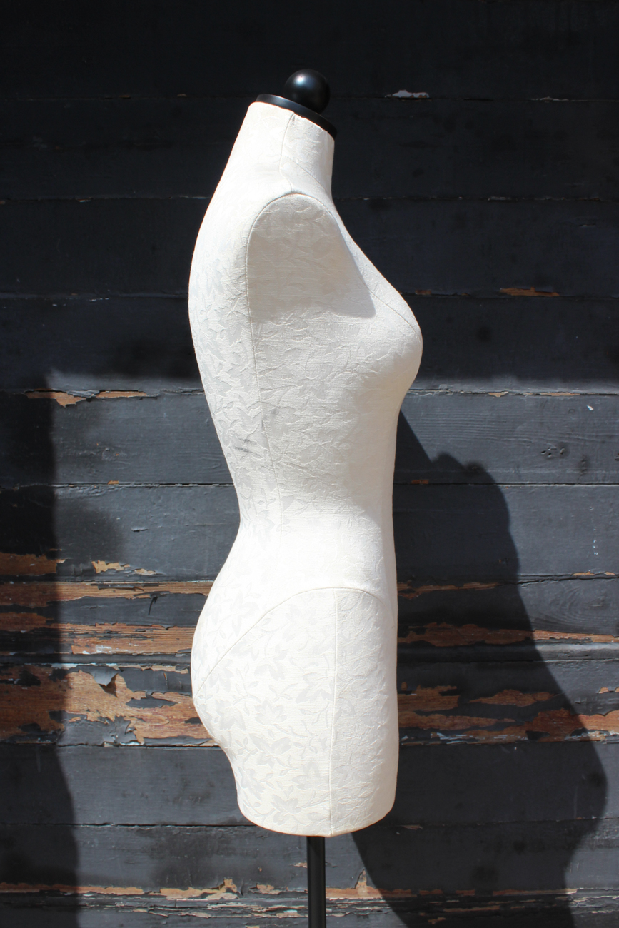 White Upholstered Dress Form On Wrought Iron Stand