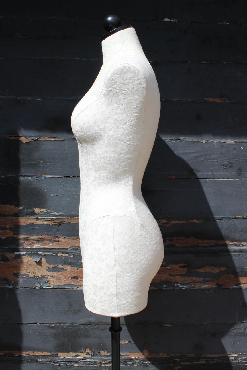 White Upholstered Dress Form On Wrought Iron Stand