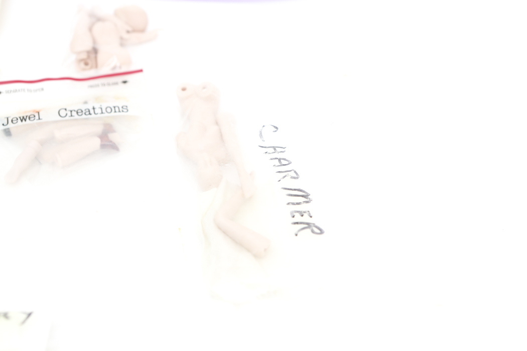 Collection of Small Doll Parts and Stands