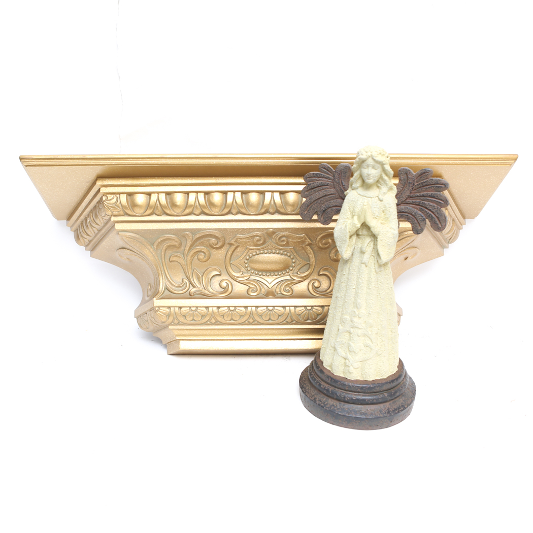 An Ornate Gold Wall Shelf and an Angel Figurine
