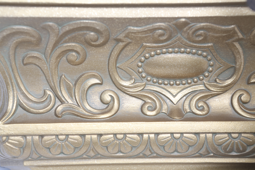 An Ornate Gold Wall Shelf and an Angel Figurine