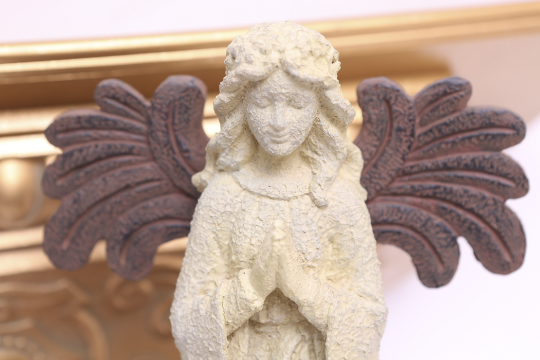 An Ornate Gold Wall Shelf and an Angel Figurine