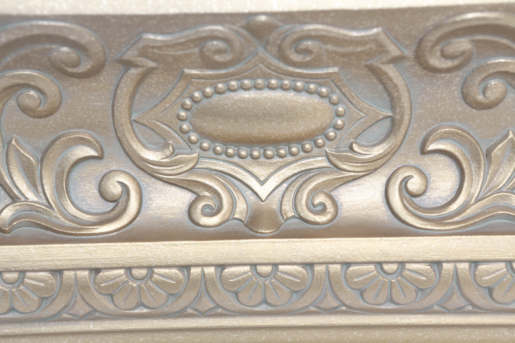 An Ornate Gold Wall Shelf and an Angel Figurine