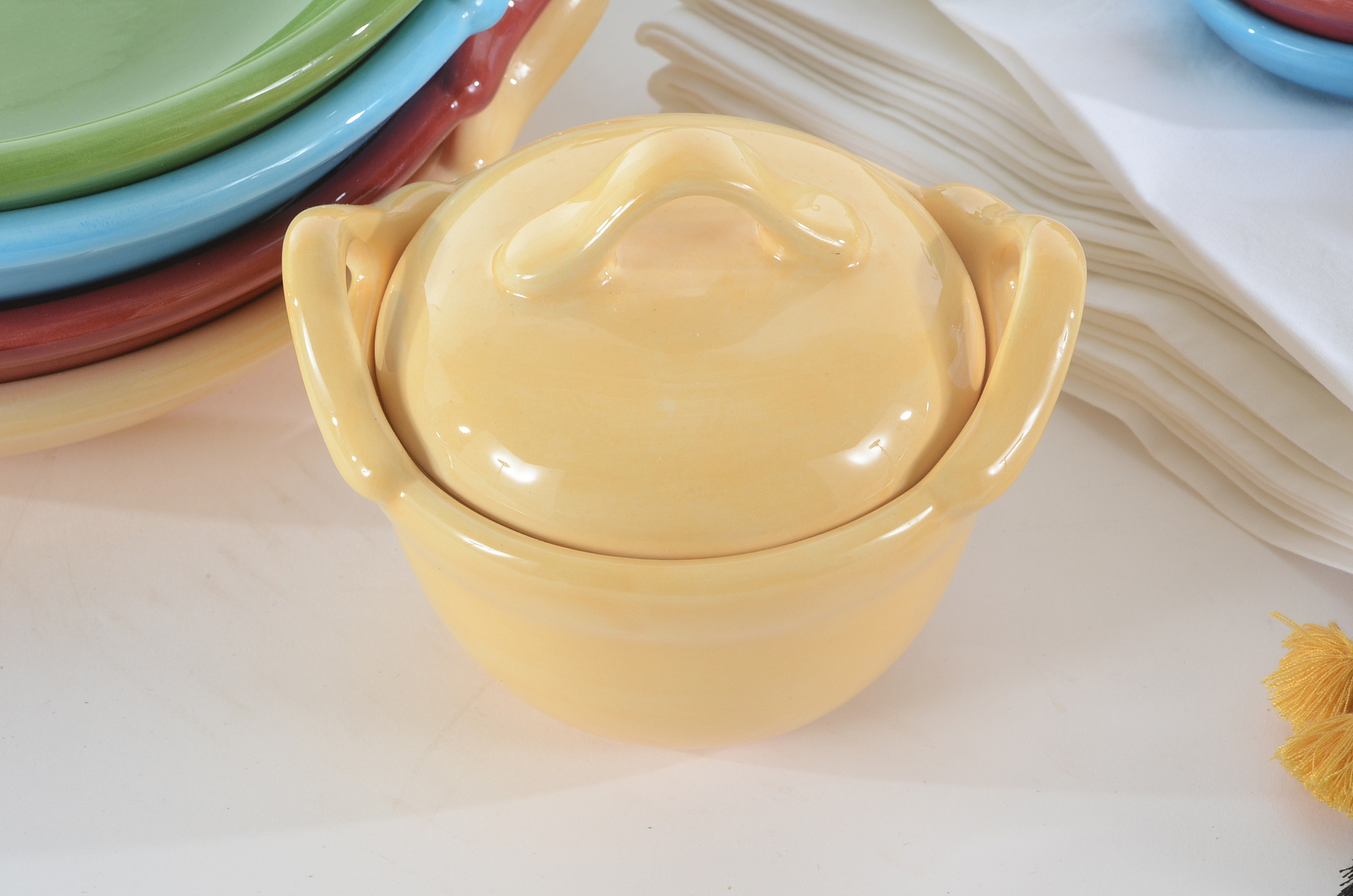 Collection of Pottery Barn Fiesta Ware Dishes and Placemats