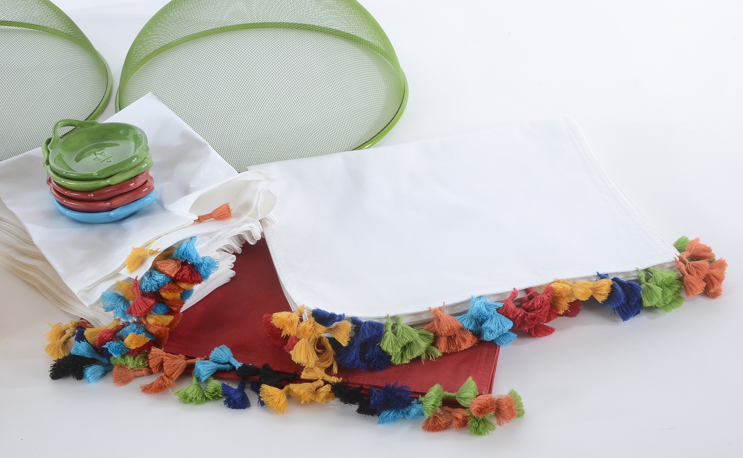 Collection of Pottery Barn Fiesta Ware Dishes and Placemats