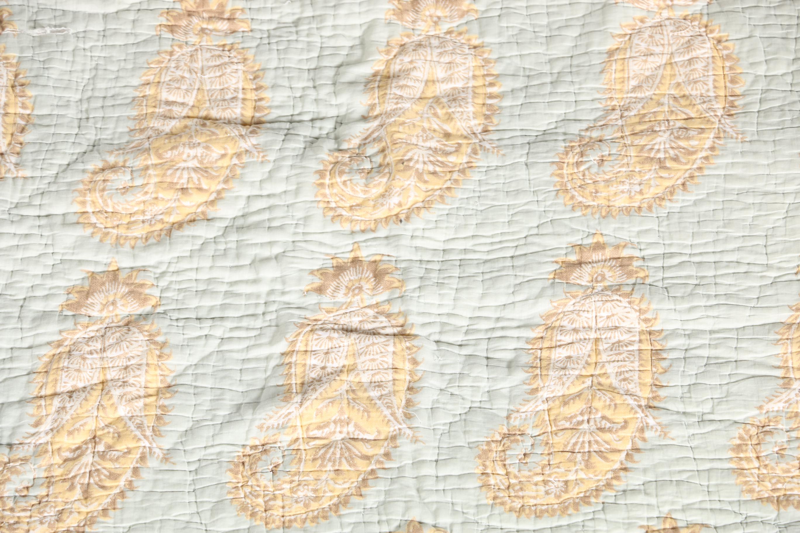 Blue and Tan Quilted Bedspread