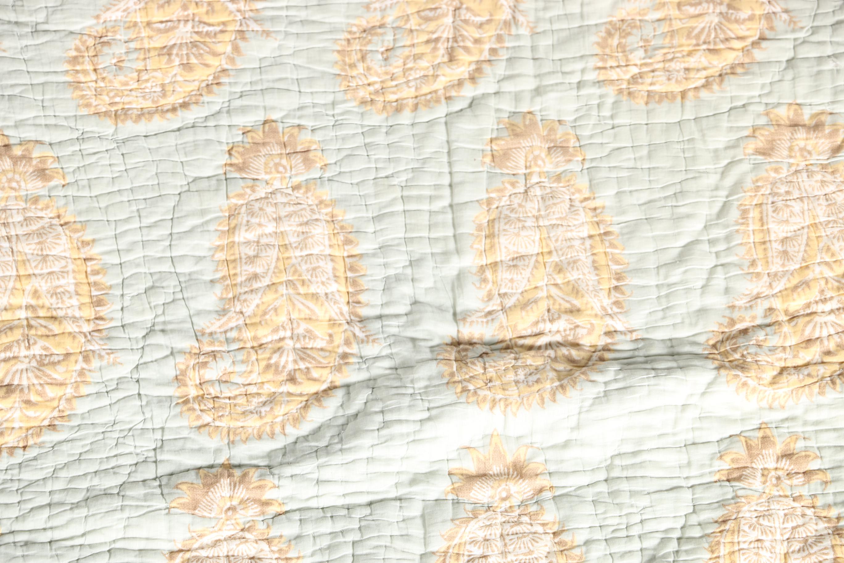 Blue and Tan Quilted Bedspread