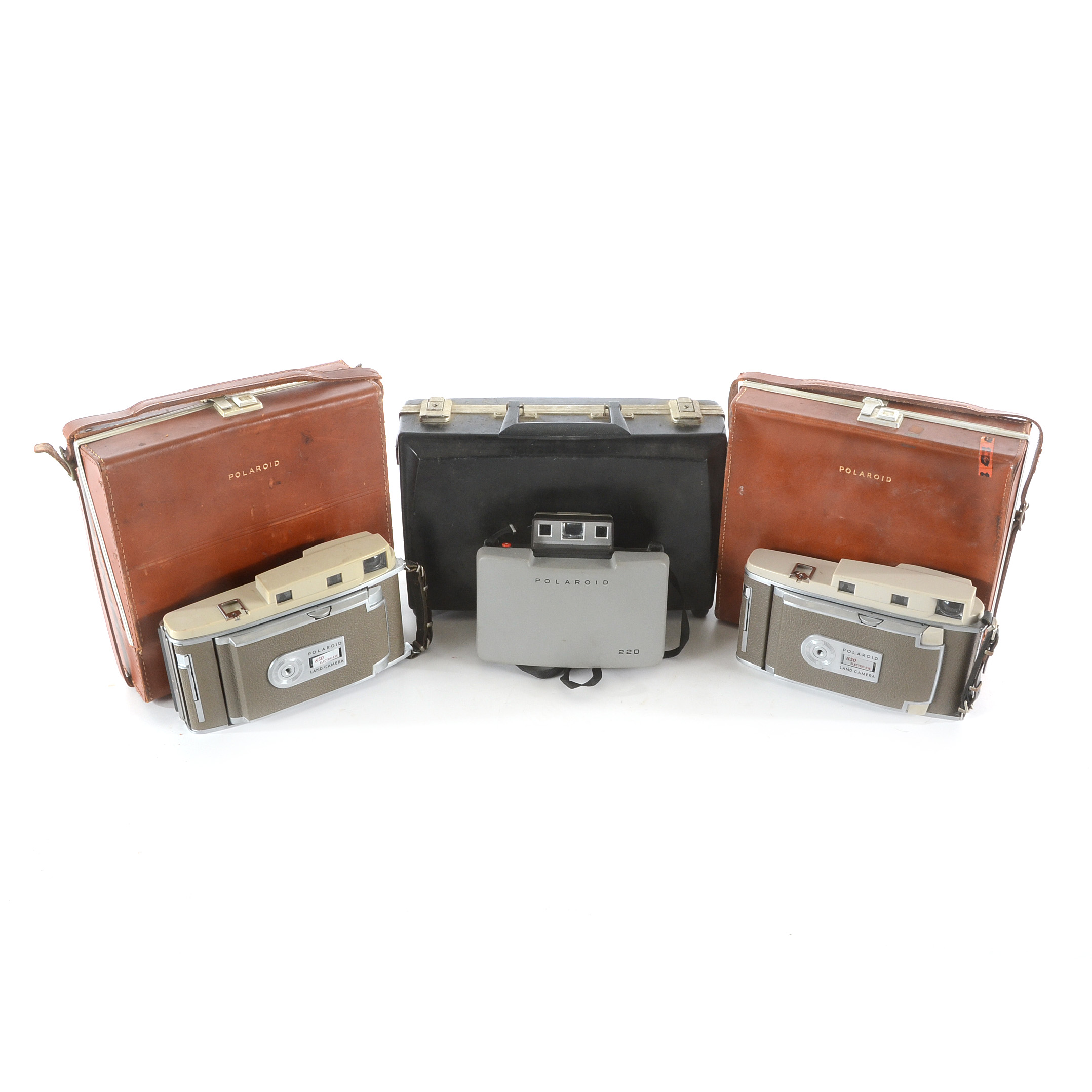 Three Vintage Polaroid Cameras in Cases