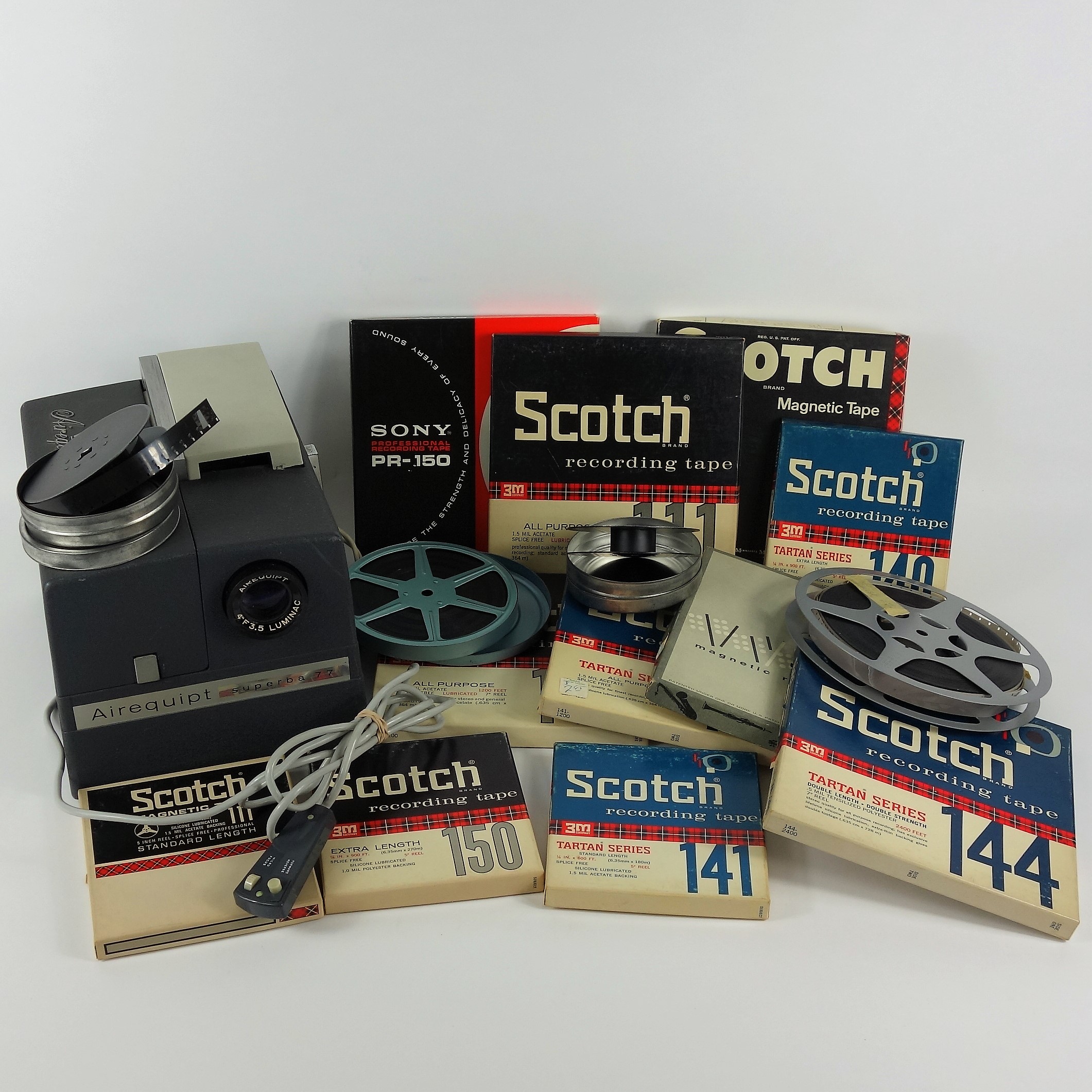 Projector and Vintage Tape Reels With News, Other Recordings