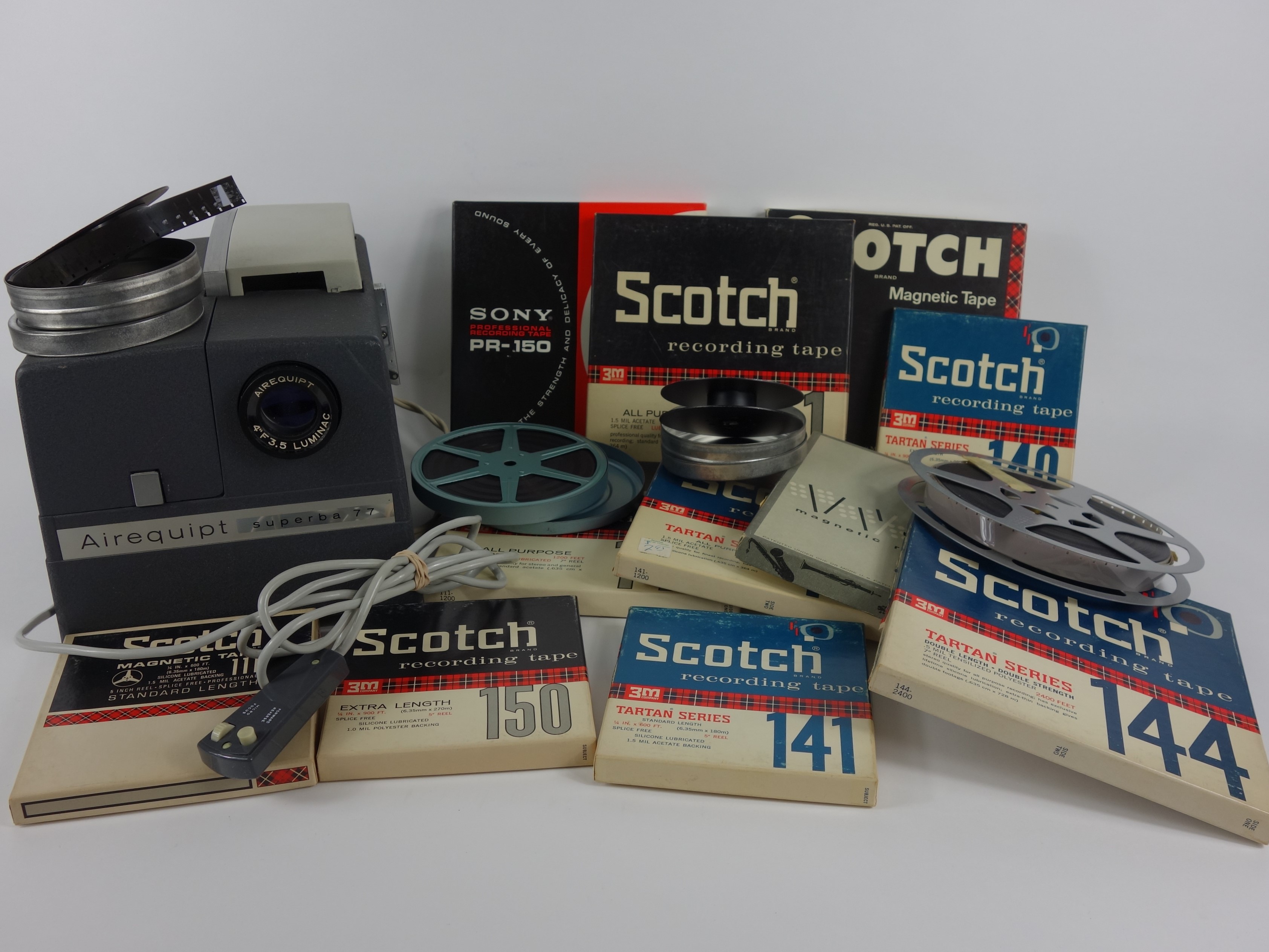 Projector and Vintage Tape Reels With News, Other Recordings