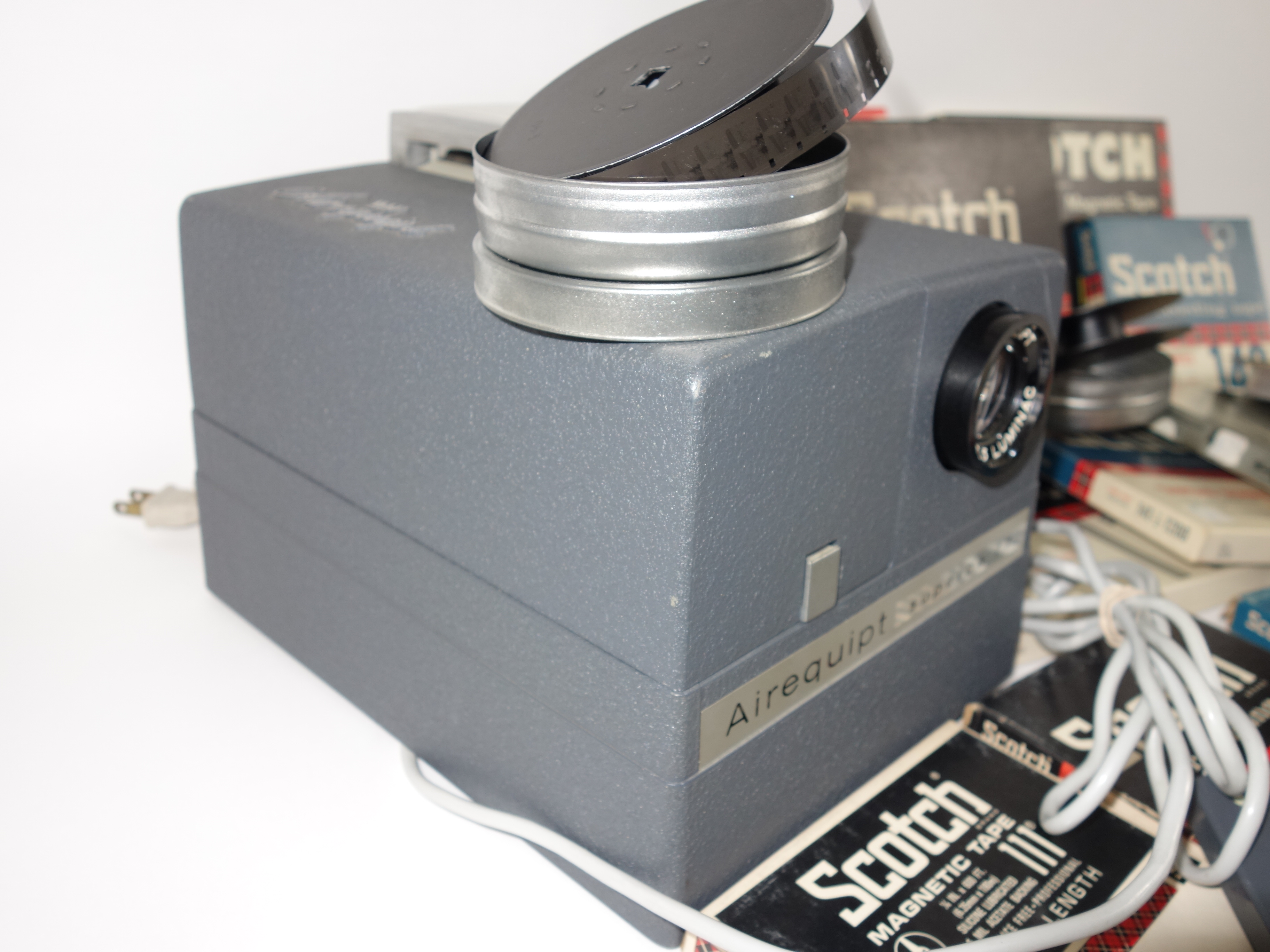 Projector and Vintage Tape Reels With News, Other Recordings