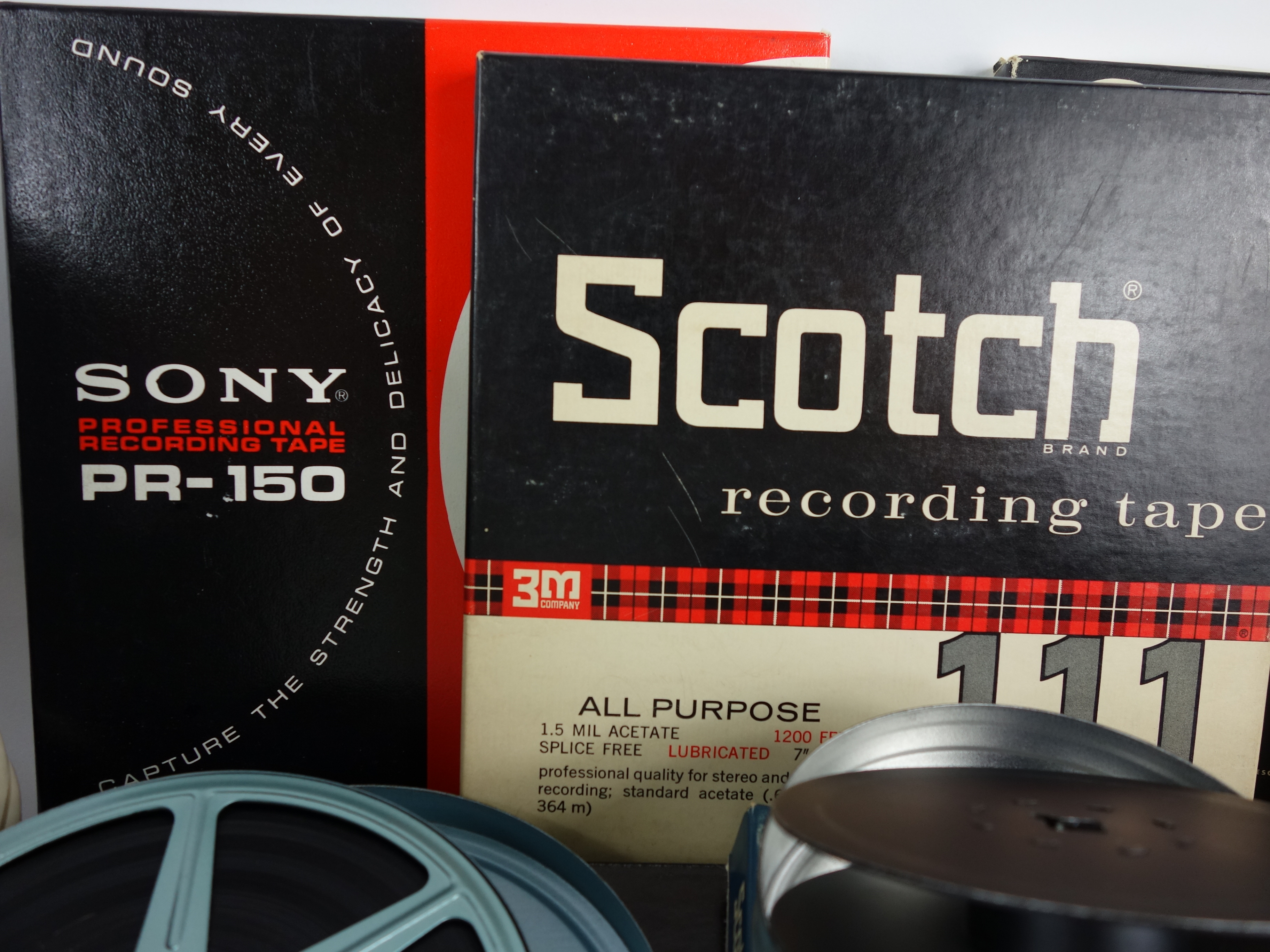 Projector and Vintage Tape Reels With News, Other Recordings